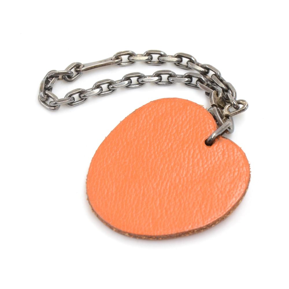 Hermes orange bag charm. HERMES engraved on the inside of the green leather leaf.  Very cute accessory which would look great hanging from your leather bag or even keys! Size: Total length including the chain is app 4.1 inches or 10.5 cm.The apple