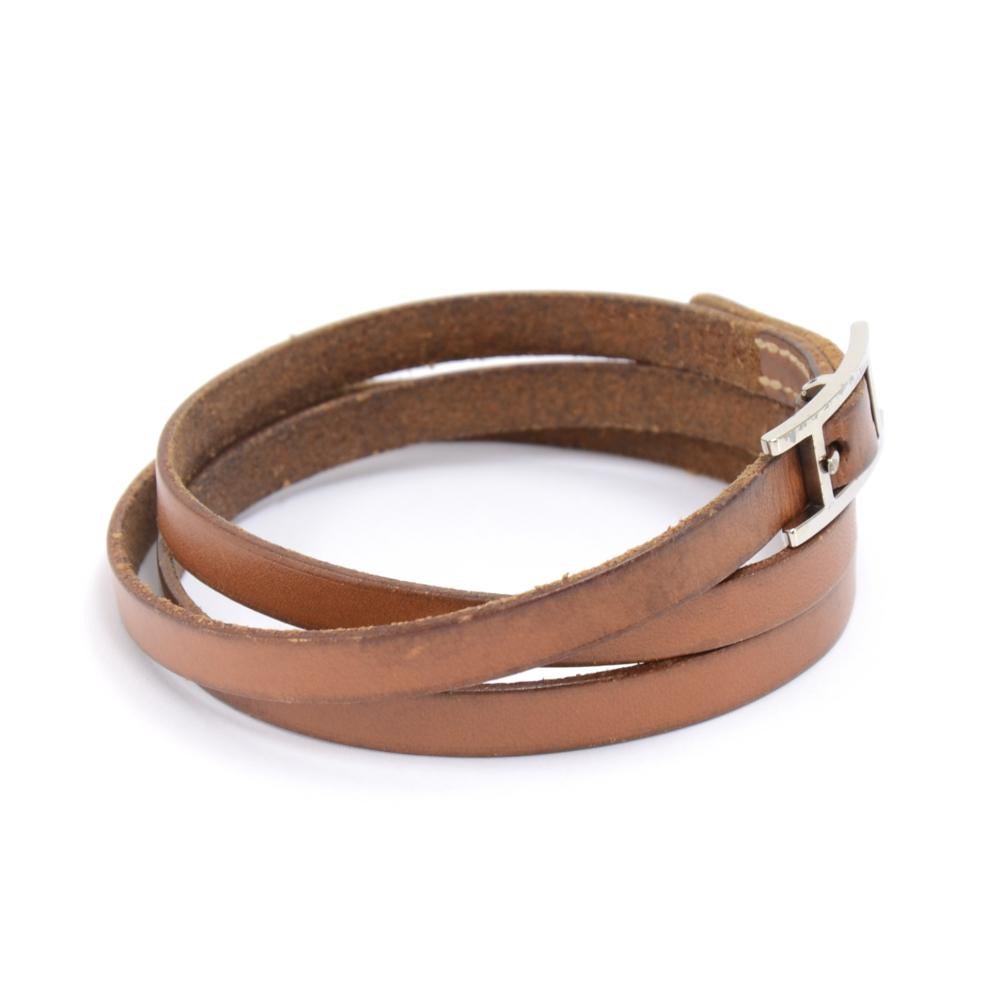This is Hermes Api III brown leather long wrap bracelet. It has a silver toned Hermes's 