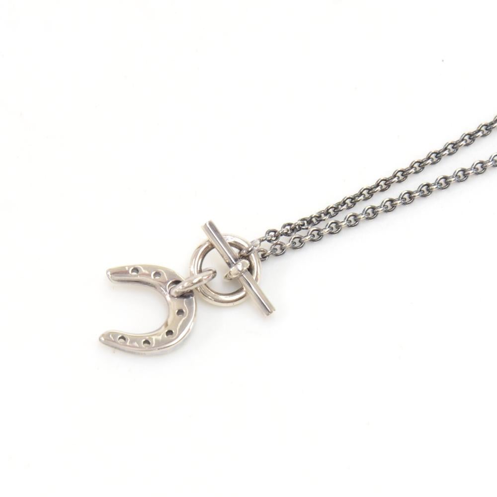 Hermes lucky horse shoe necklace. It has a silver chain with a toggle clasp. Very simple, elegant and also iconic Hermes necklace! SKU: HA942
Necklace Drop approx: 7.3 in or 18.5 cmPendant length approx: 0.6 in or 1.5 cm

Made in: France
Color: