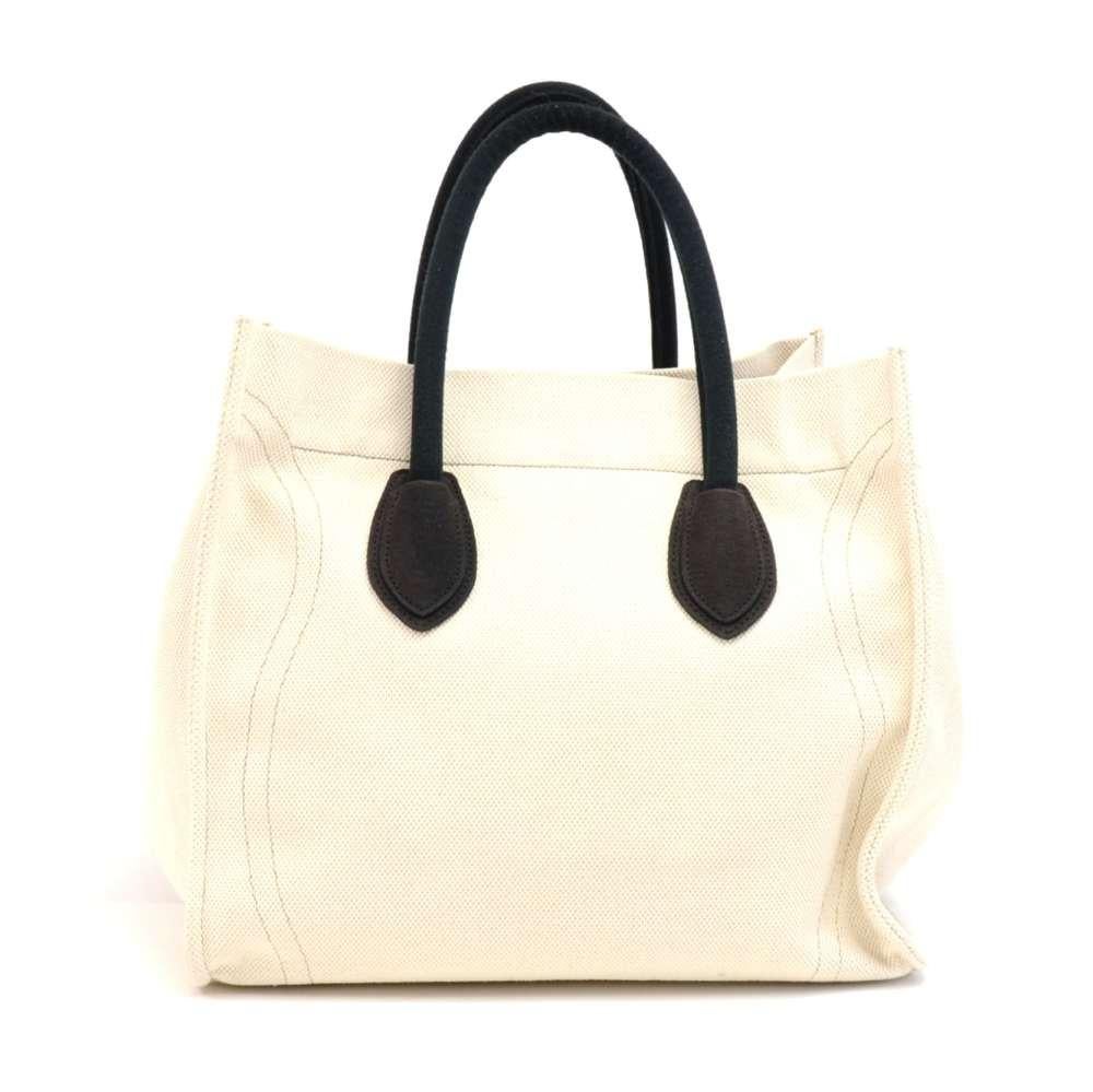 Celine Phantom Luggage Tote Bag in Beige Canvas. This is a twist on the classic leather phantom Celine bag with more lightweight beige canvas featuring a front zipper pocket, and black & brown canvas details. The inside can be secured with two black