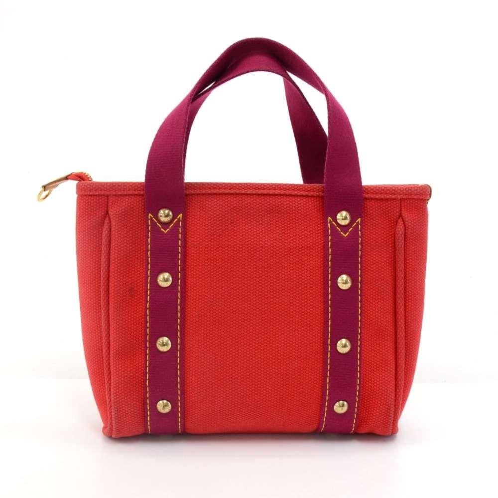 This is Louis Vuitton red antigua 2006 limited edition MM hand bag. The bag is secured with a zipper and the inside has cotton lining with one open pocket. A gold tone metal plaque on the front with 