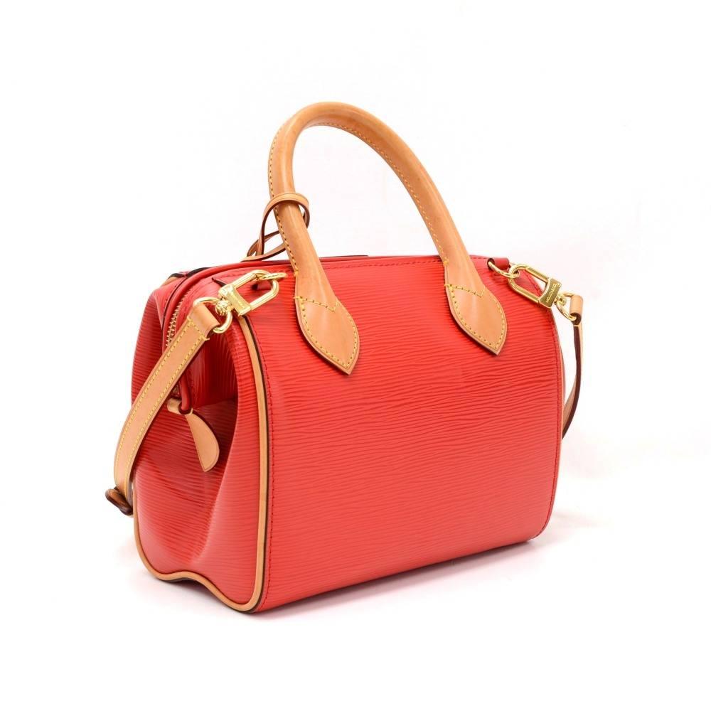 Louis Vuitton Doc BB bag in red coquelicot epi leather. Top is secured with a zipper. Inside has beige lining and 1 open pocket. Can be carried on shoulder or across body.  

Made in: France
Serial Number: F L 2 1 7 4
Size: 9.4 x 5.9 x 2.4 inches or