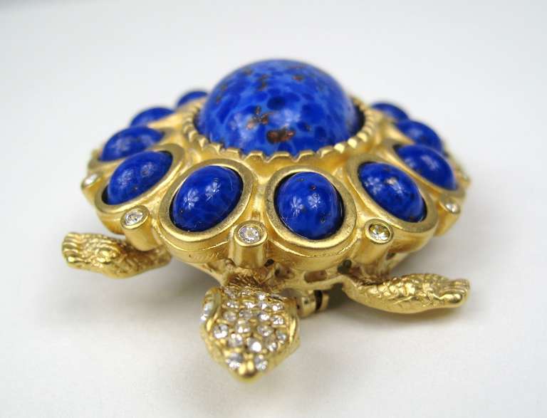 A signed Kenneth Jay Lane (KJL), gold Gilt Swarovski crystal.
 lapis blue art glass cabochon
This striking figural piece is unique, a magnificent color, weighty, unworn and measures 
2 1/2