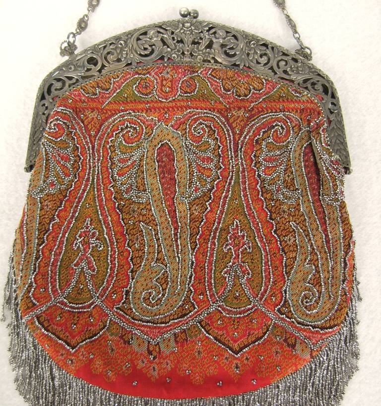 This is a gem!
* Cherub motif on the frame
* Steel beading on the handbag as well as the fringe 
* Provence attributed to the Anheuser Busch family 
* silk lining intact 
measures 12