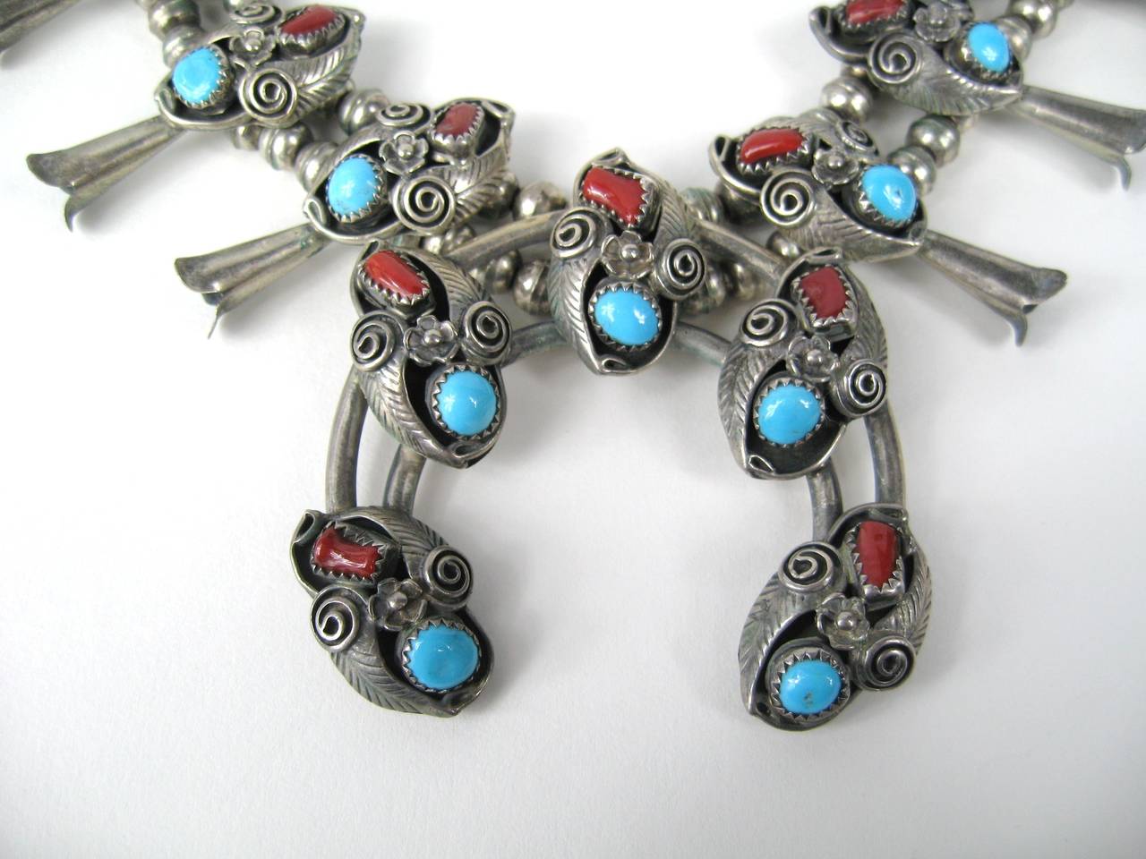 Old Pawn Navajo Blood Red Coral & Turquoise Sterling Squash Blossom 
Hallmarked V.B. 

Measuring 
Naja is 2.47