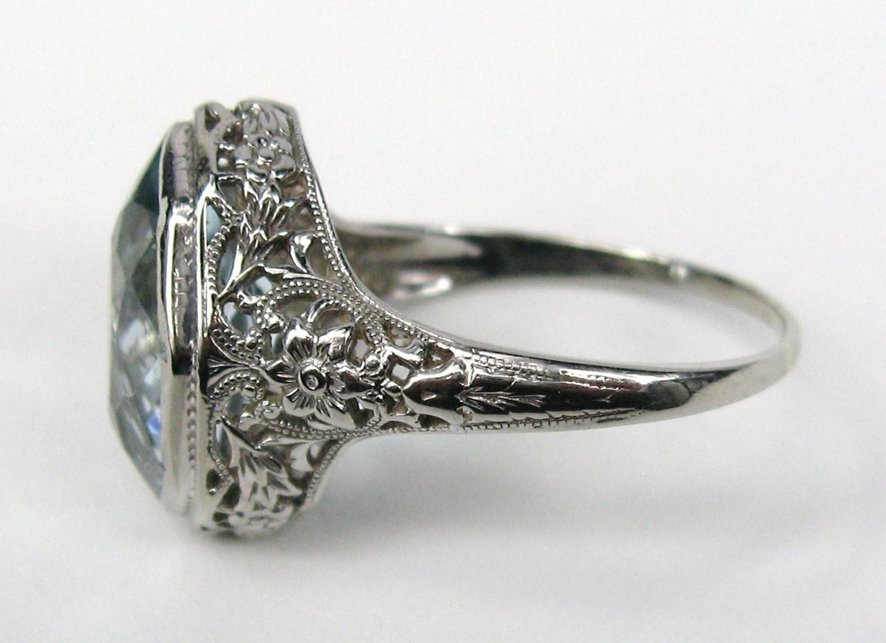 GORGEOUS 1920's or 1930's vintage
 14k solid white gold filigree ring with a large blue topaz gemstone. 
Ring is a size 8.75