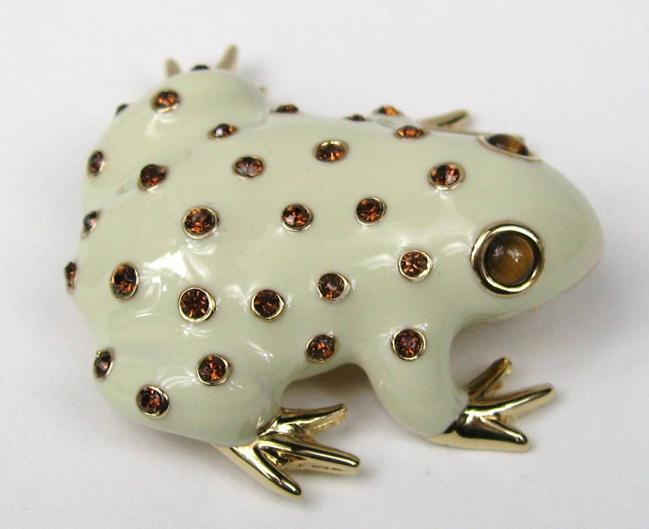 Enameled Beige with amber crystals Frog Brooch 
Ciner New Old Stock Tags still attached

Measures 1.77