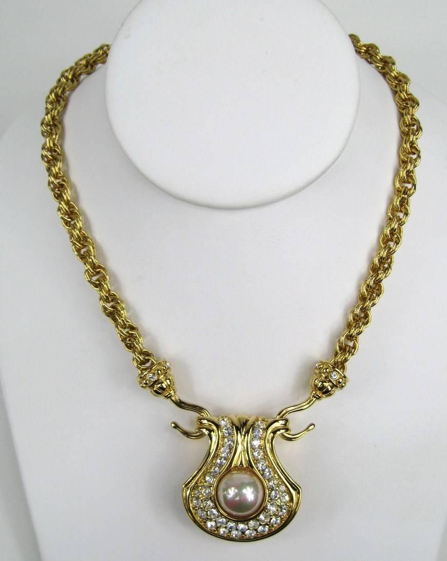 Pendant is in gold plate with pave set encrusted in Austrian crystals. This can be worn 3 ways, the enhancer can be turned around to display the gold tone side, or the Crystal side. You can also wear the chain by itself.
Our client purchased this