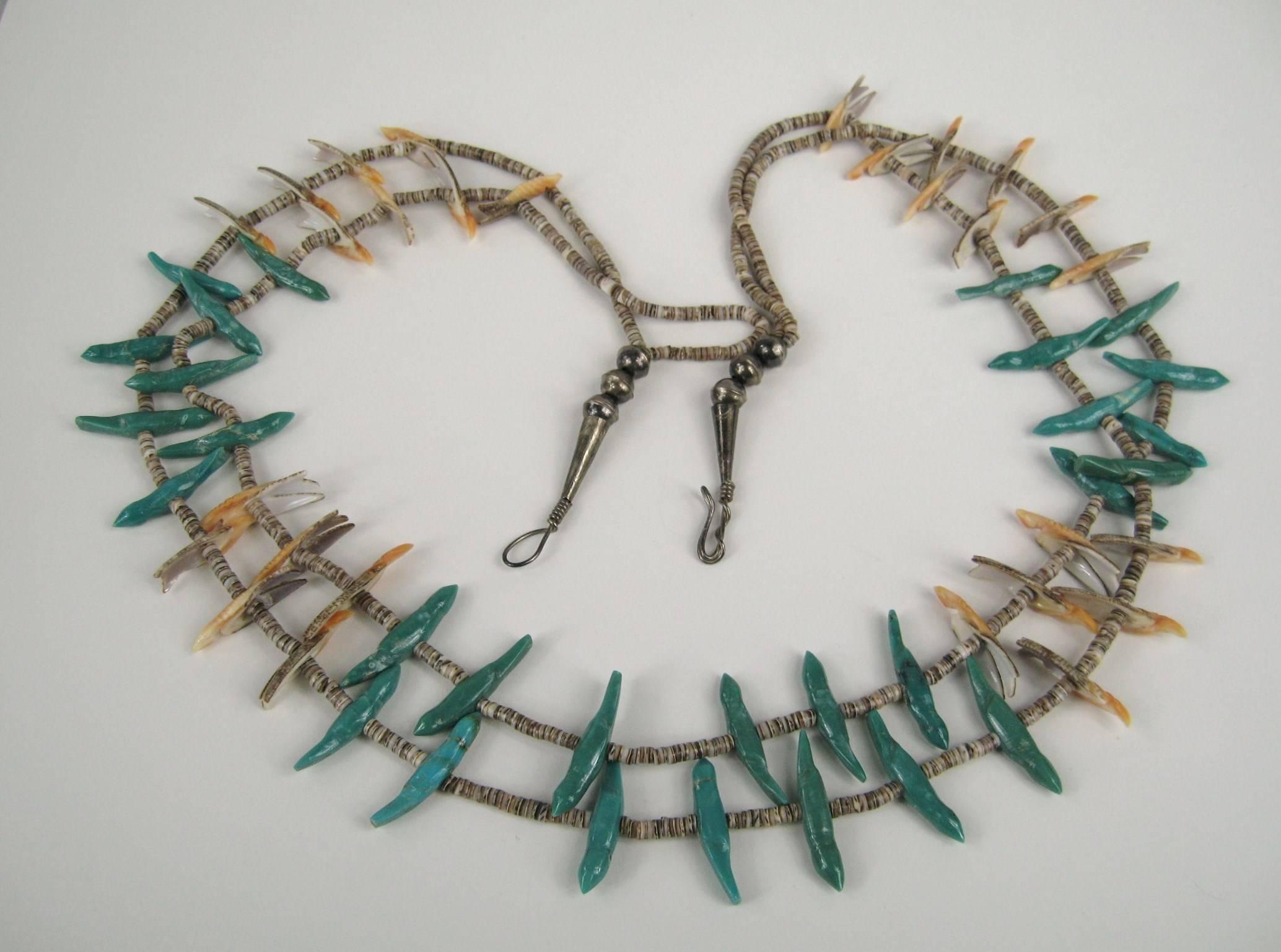 Necklace with 2 Strands of Unique Shell & Turquoise Bird Fetishes
Each Hand Carved 
Strung with Turquoise and Exotic Shell Heishi Beads

Hook Closure 
Measures
34