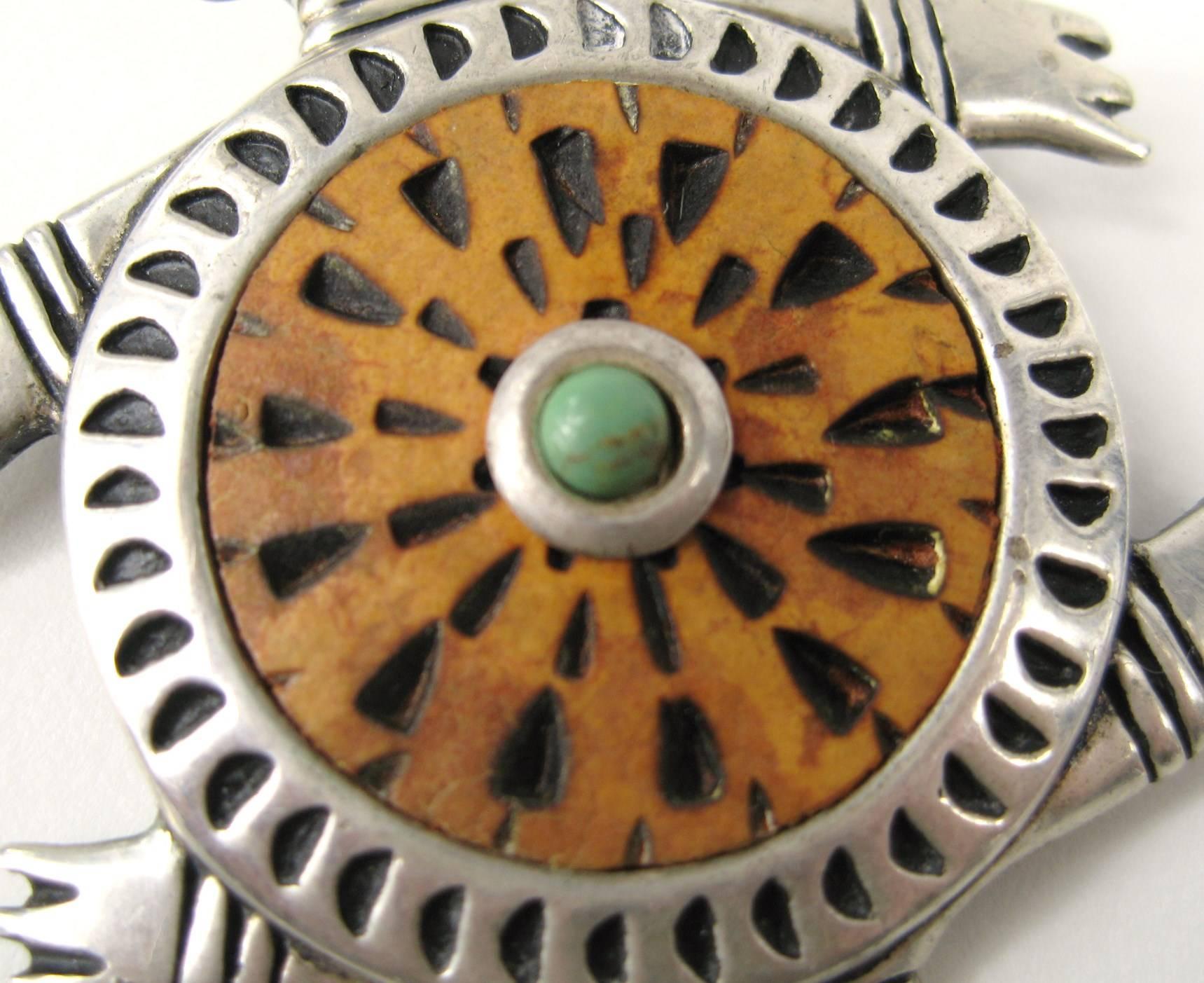 This is adorable, Stunning design 
Set in Sterling silver with carved wood center, bezel set Turquoise 
Measures 
2.23