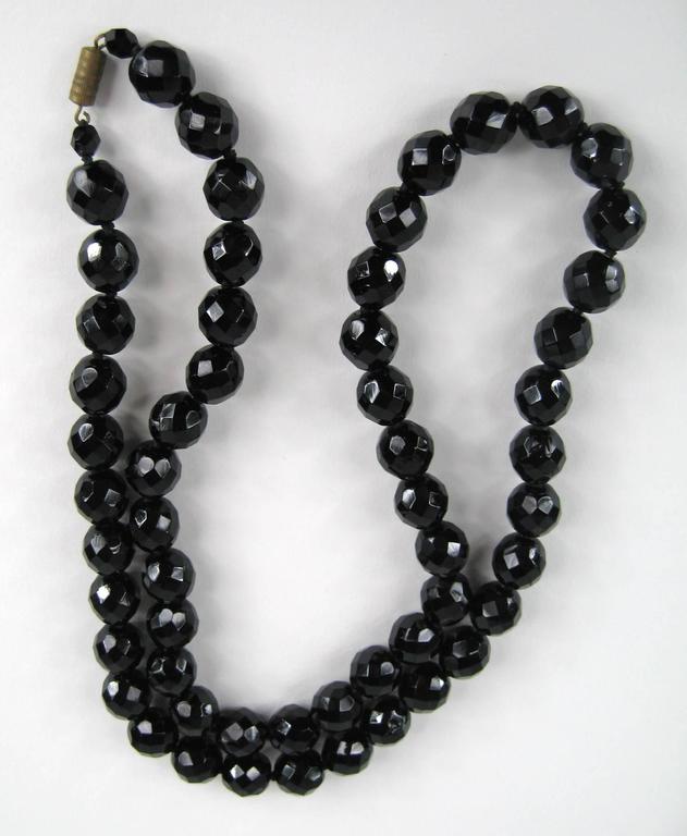 Black and white glass beads necklace with a vintage black enamel  belt buckle