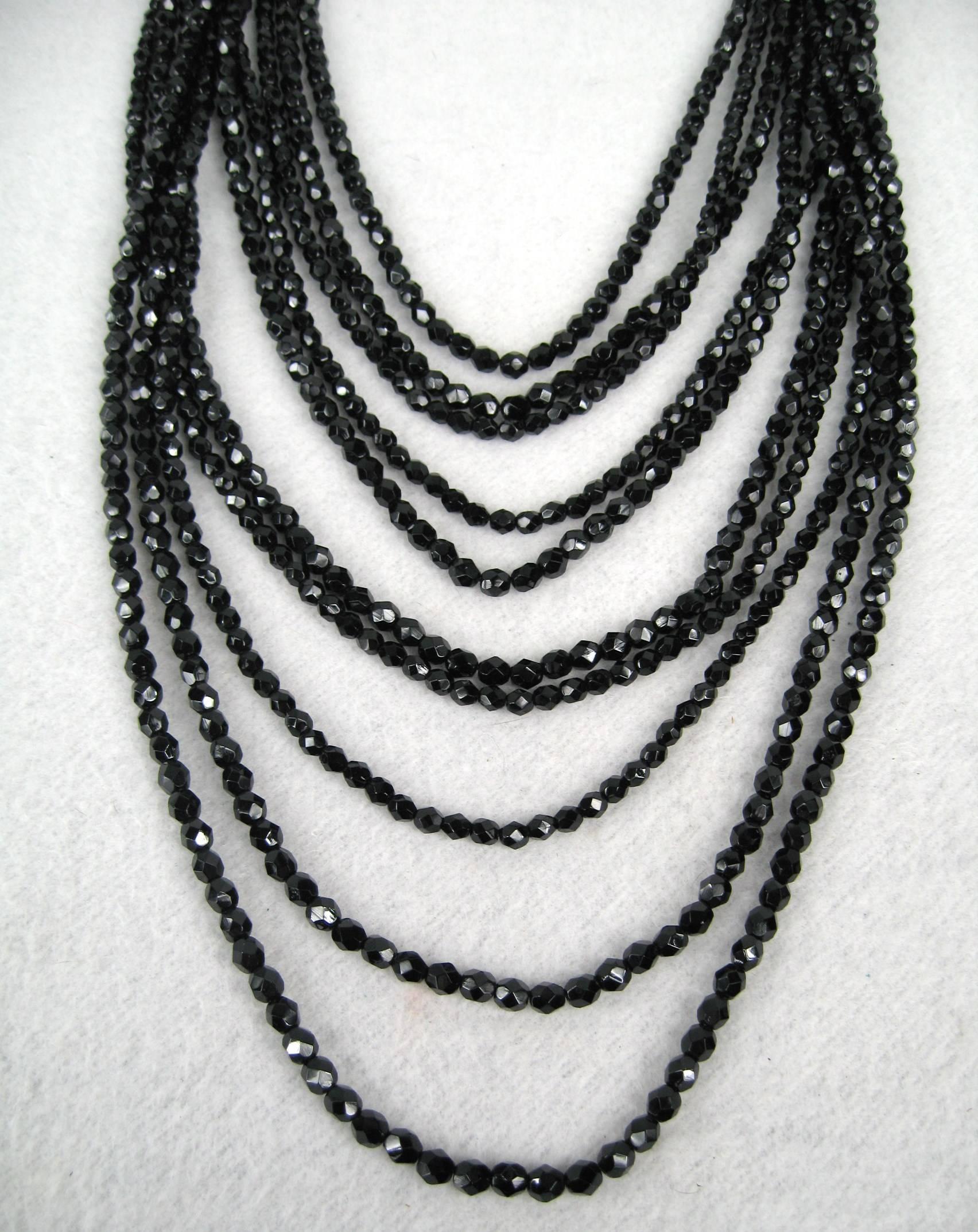 This is an exquisite piece
11 strands of faceted glass Beads
Draping from 13