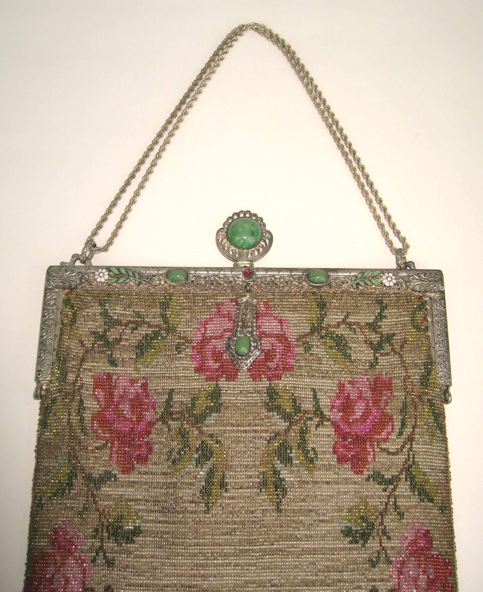 This is a amazing handbag, lined in silk. Most likely french.
Cabochons stones on the frame in Green 
Large clasp 
Fringe still in tact at the bottom
Comes with its original change purse and mirror
Measures 7-7/8