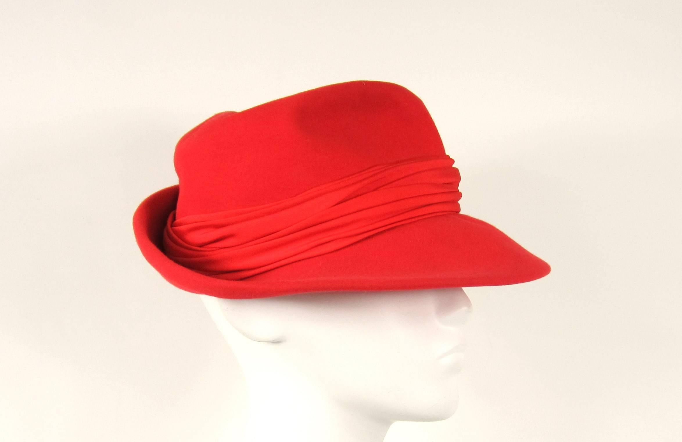 Stunning bold Red Fedora Saks 5th Ave 
1960s 
Wool 
23.5 in 
Brim 3 in
Large Ribbon around crown of hat 
Any questions please call, email or hit request more information 