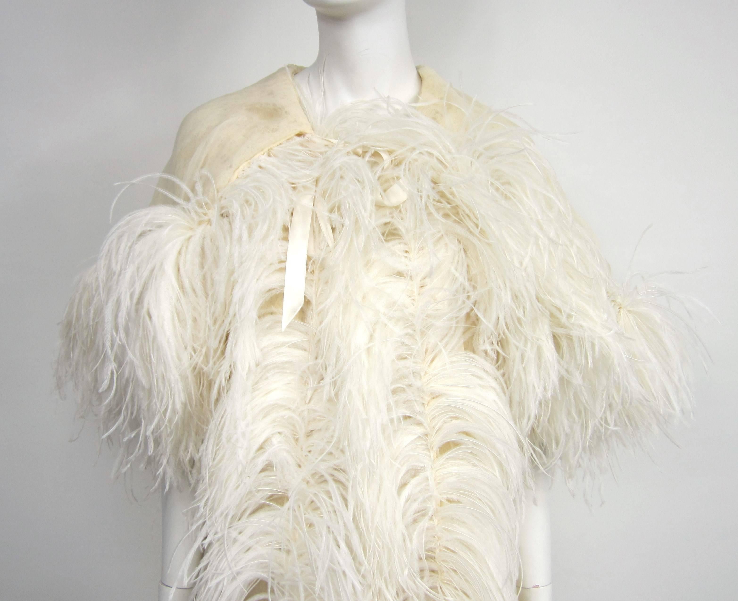 This is stunning in person
Feathered all down the front and around the hood
Ribbon tie at the neckline
Lined with cream colored netted fabric 
Will fit a Small- Med
Comes with a night gown which is more a small
Beaded bodice 
Any questions