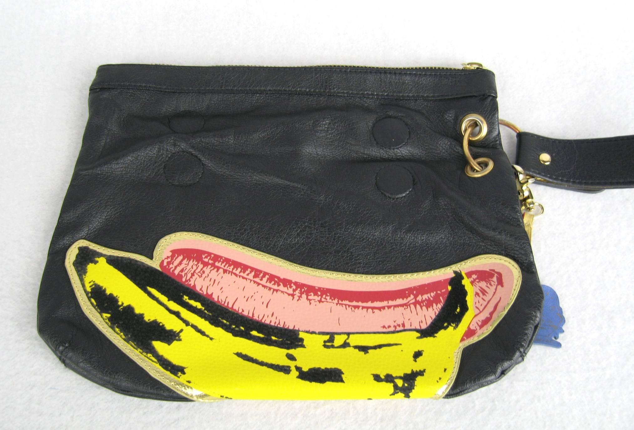 Black leather.zippered top with oversize gold tone zipper 
Banana motif on the front to the handbag 
Looks to be not used 
Measuring  10