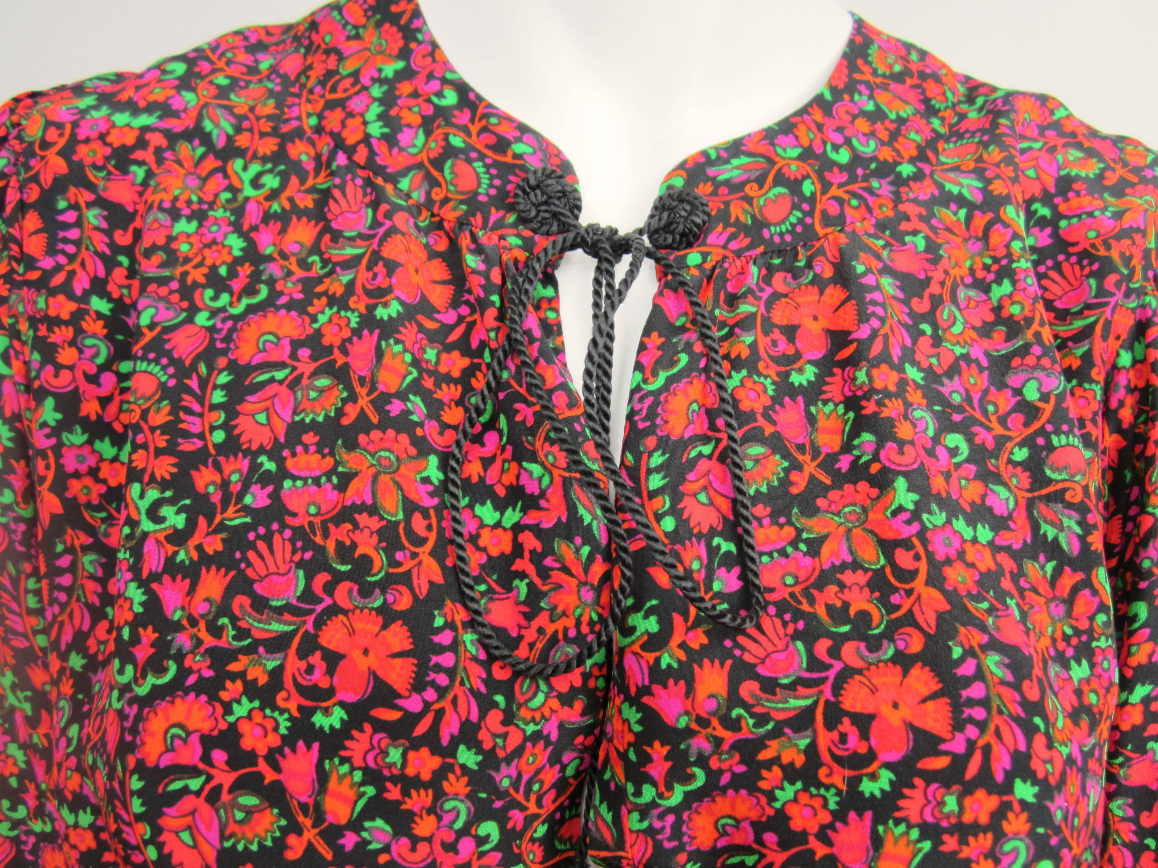 Stunning color on the vintage YSL Silk top 1976 Collection Russian 
The gorgeous print silk of this YSL blouse features rich colors, splashed together creating an abstract, paintbrush effect!
Deep V plunging peek a boo 
Rope tie up 
Button cuffs