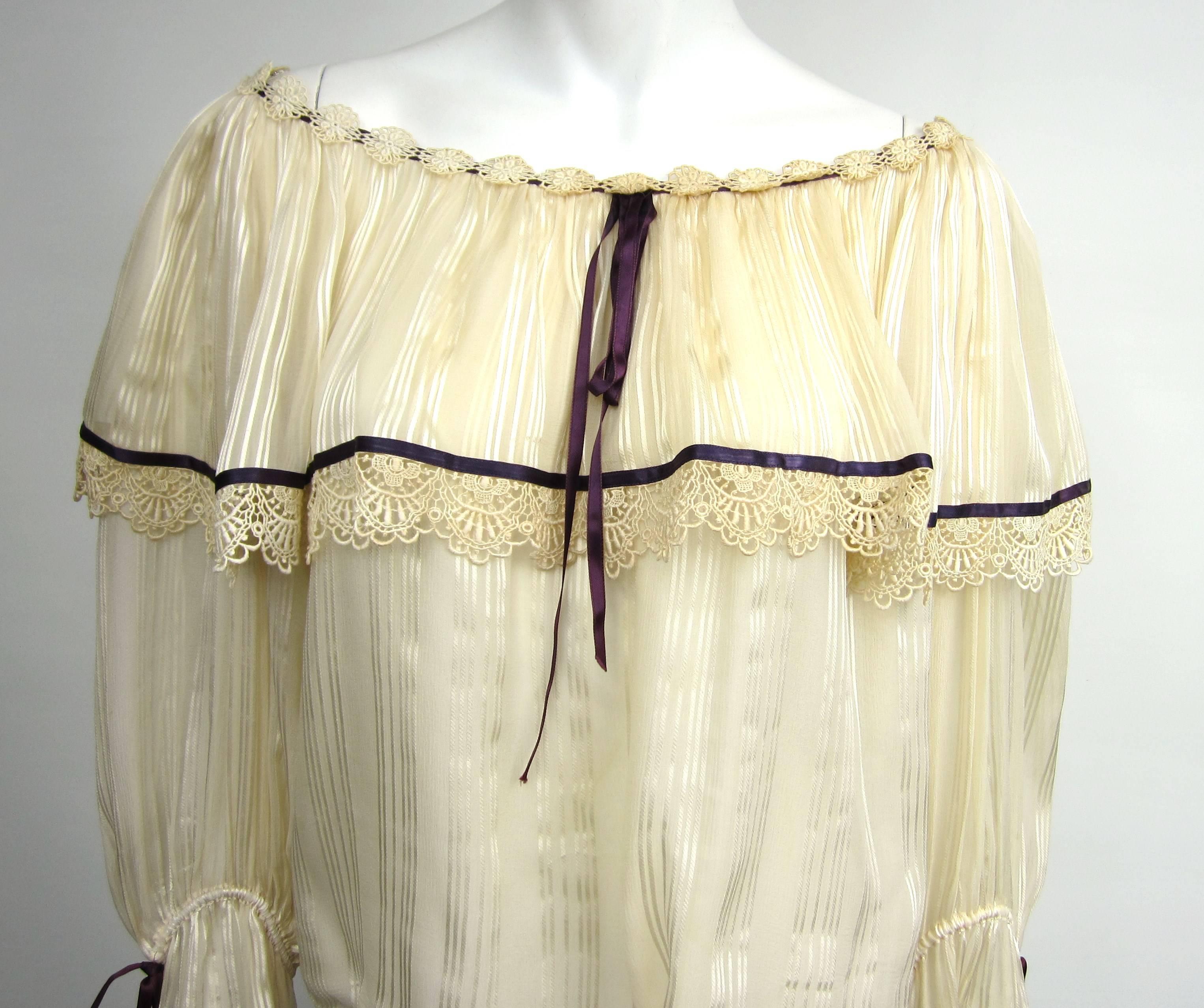 Boho 1970s Numbered YSL Silk Cream / Purple Top
Ribbon accents on the cuff. Large Ruffle on the bodice 
Lace across the shoulders 
Numbered 41467
Measuring 
Up to 42