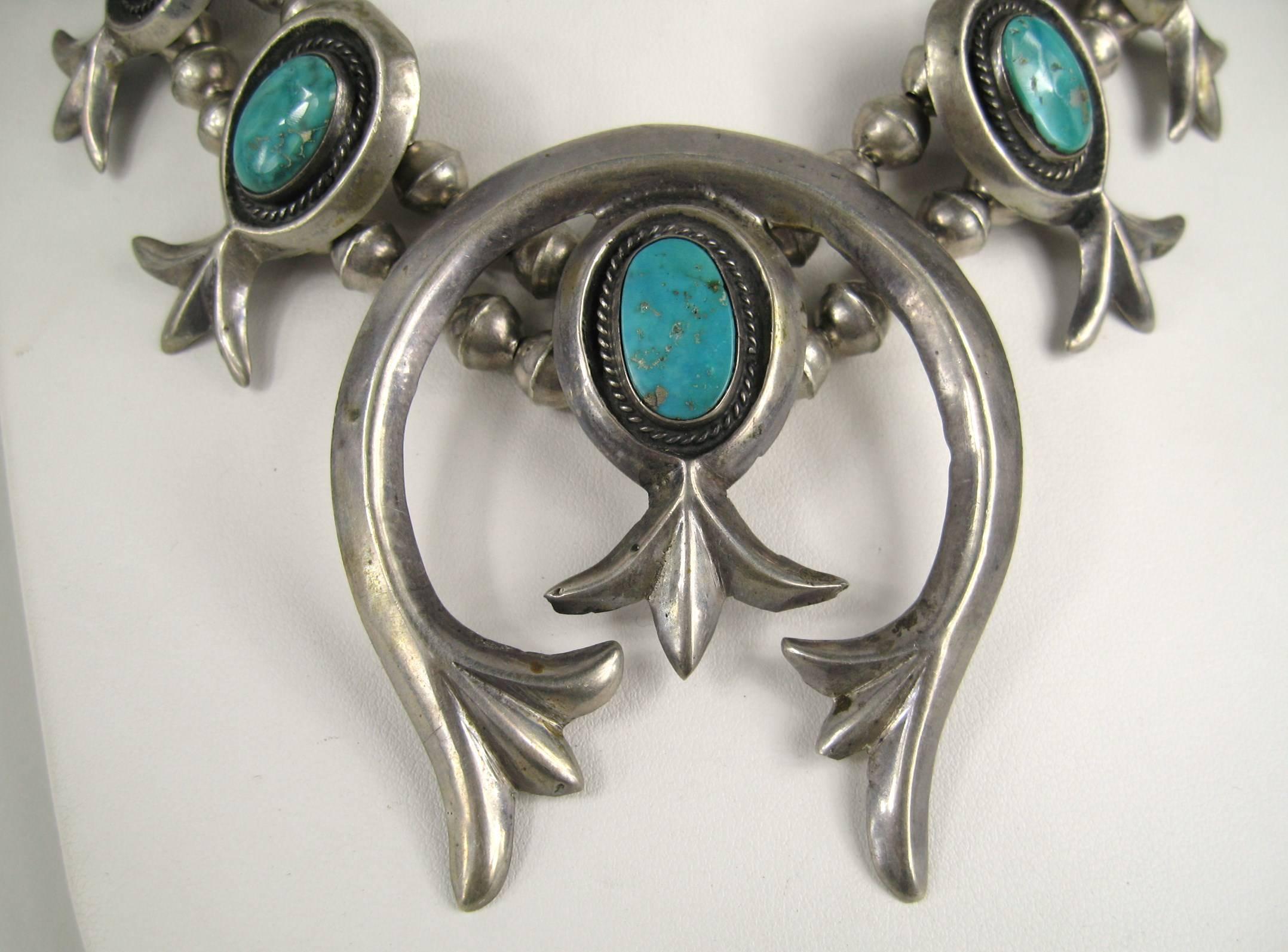 Gorgeous Old Pawn Navajo Squash Necklace. Large Naja at the center 
Double beaded chain 
Sterling Silver Sand cast 
A variety of turquoise stones set in this one 
Chain is 26