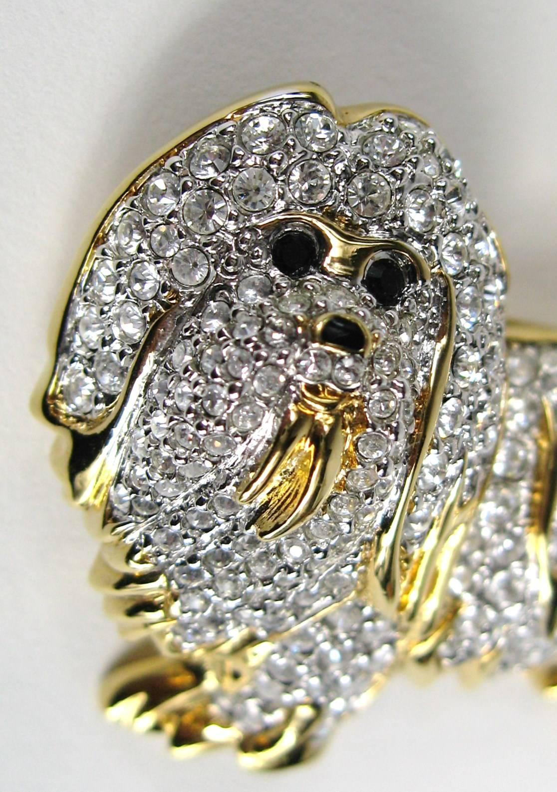 Just sweet, this Maltese Dog Brooch designed by Swarovski 
1999 Swarovski Trunk Tour Show and is one of 46 of the pins where Swarovski introduced the best of the best that Swarovski ever made.
 full clear colored pave' crystal with a jet nose and
