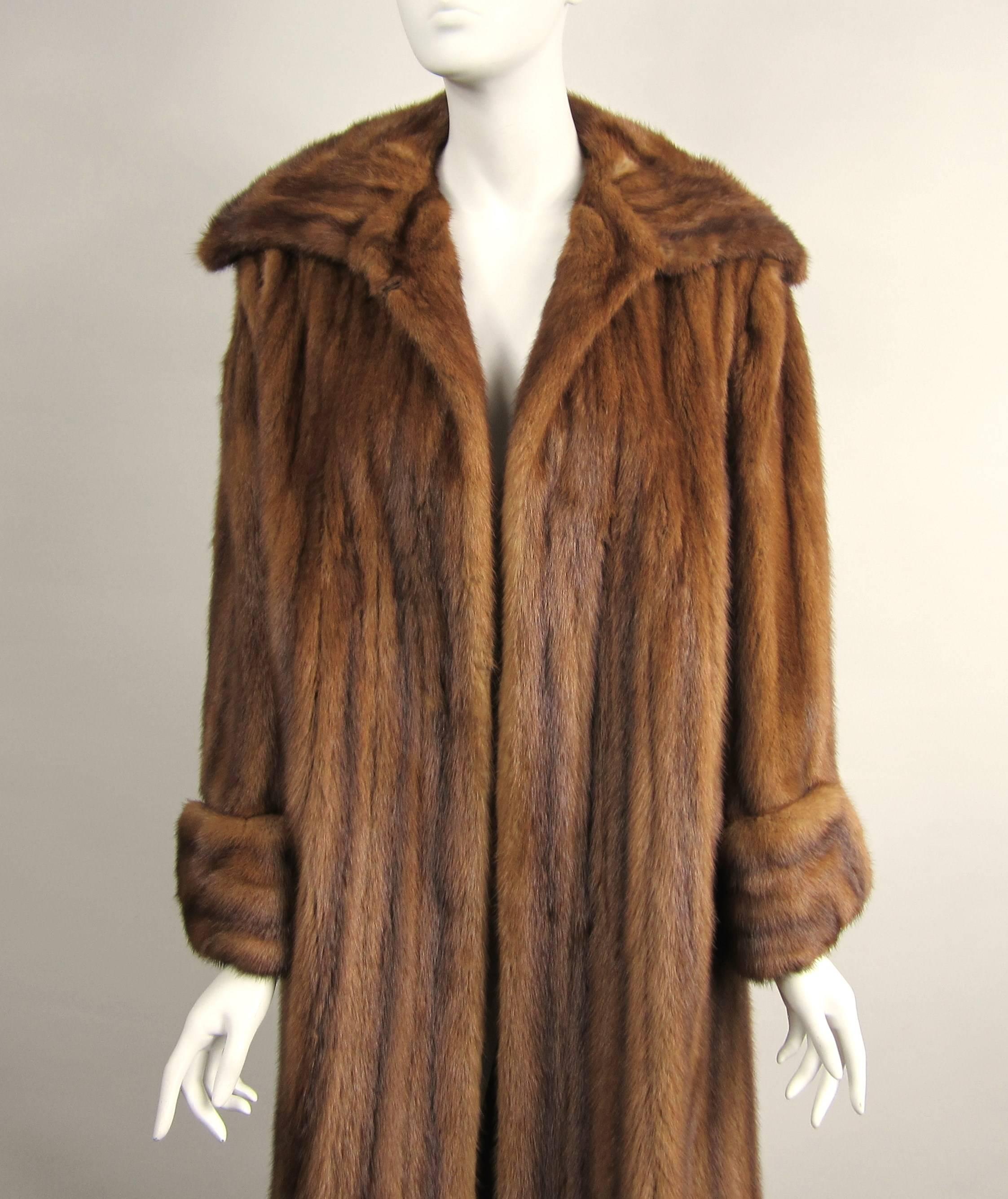 This is spectacular, Brown soft and supple swing Mink Coat 
The cuffs on this coat are stunning 
Mink is in amazing condition 
This will fit a wide range of sizes from a 10-16 
It has one eye hook at the neck which can be moved to fit larger or