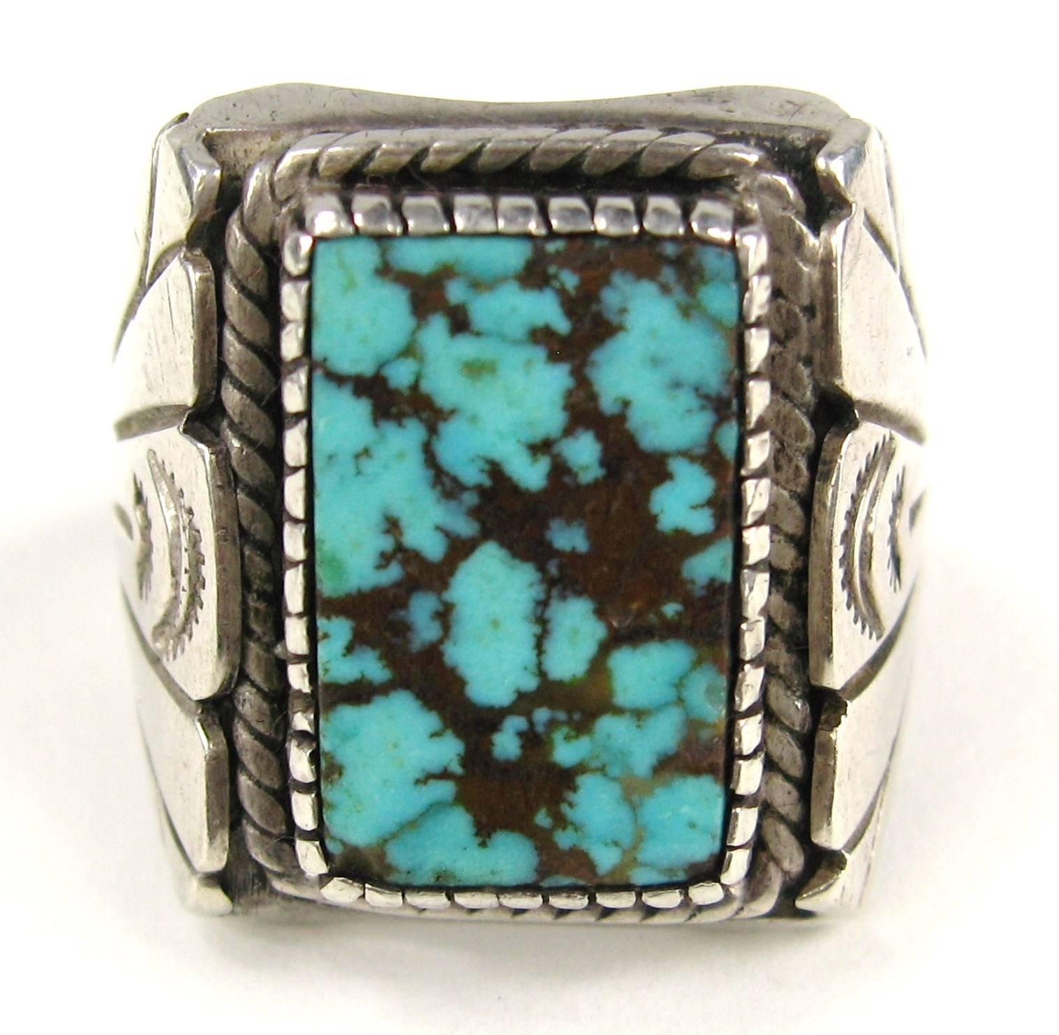  Stunning Arizona turquoise stone is a piece of spider webbed Kingman Turquoise that has an incredible rich that is filled with golden brown webbed matrix. 
Ring is hallmarked in side and marked sterling 
Ring is a size 11 and can be worn by both