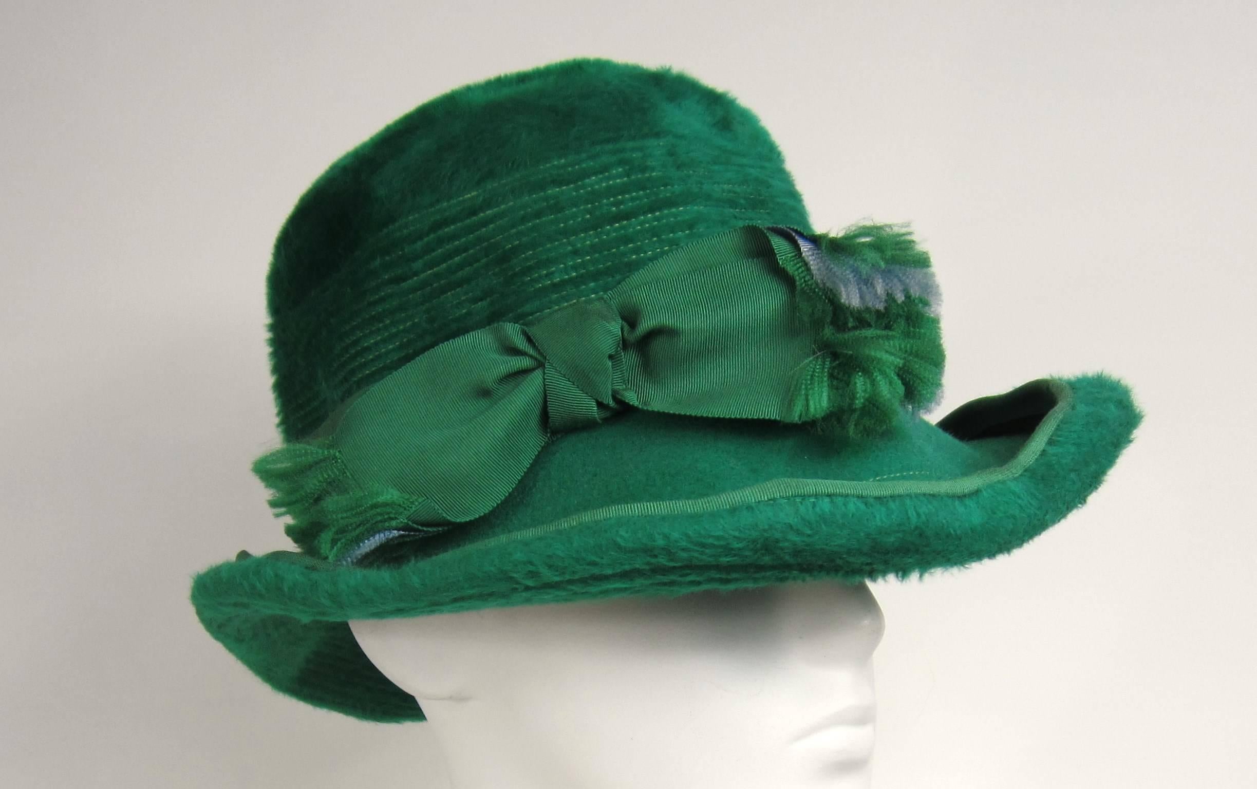 Stunning Christian Dior wide Brimmed Fedora hat. Green ribbon with a hit of purple, great color combination. Hat measures 21.75 in inside with a 3.5 in brim and is 4.5 inches high. 
Any questions please call, email or hit contact. 