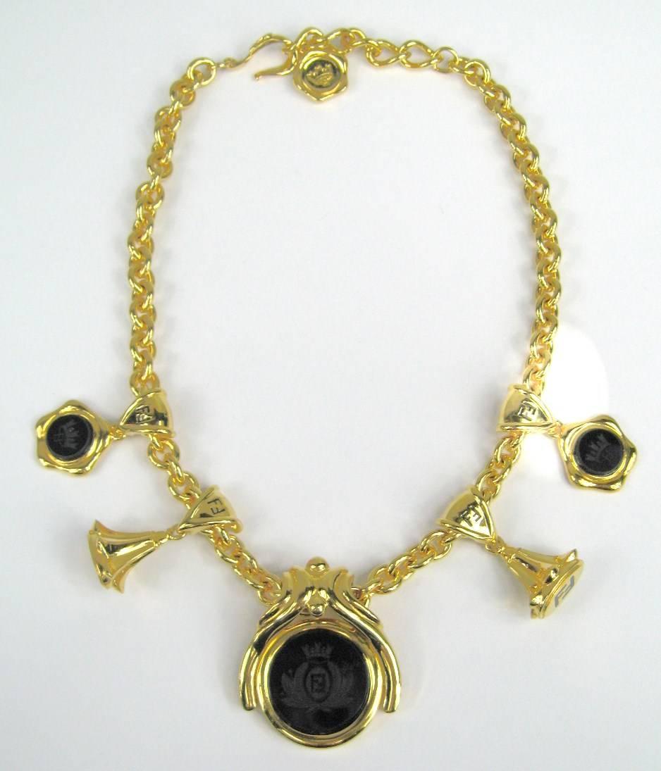 Large Chunky Fendi Necklace with Alternating Black Matte with Gold tone Stamp charms with the Fendi logo- Front Drop is reversible 1.94 inches x 1.66 inches. Necklace is 20 inches end to end but can be made to be a choker style at about 16 inches.