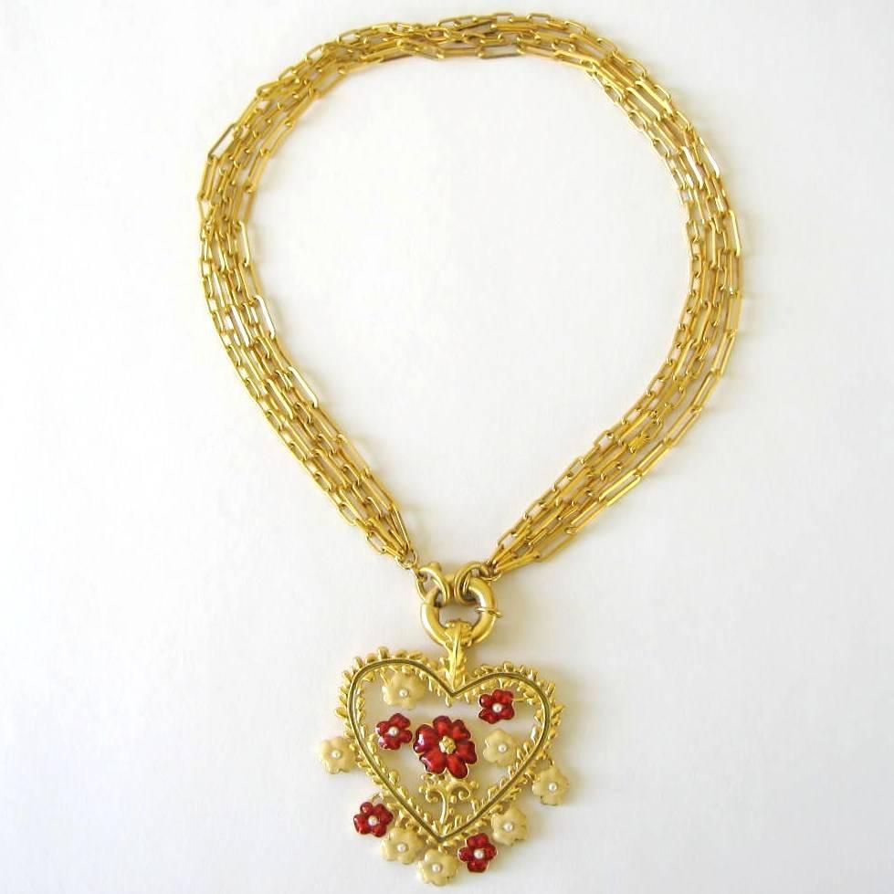 Stunning Karl Lagerfeld Heart necklace with Red and Tan enameled flowers with Tiny Pearls in center of the flowers. Nice scale to this piece. Multi Strand Gold tone chain. The pendant does detach from the chain. Chain is approx. 17 inch Long. This