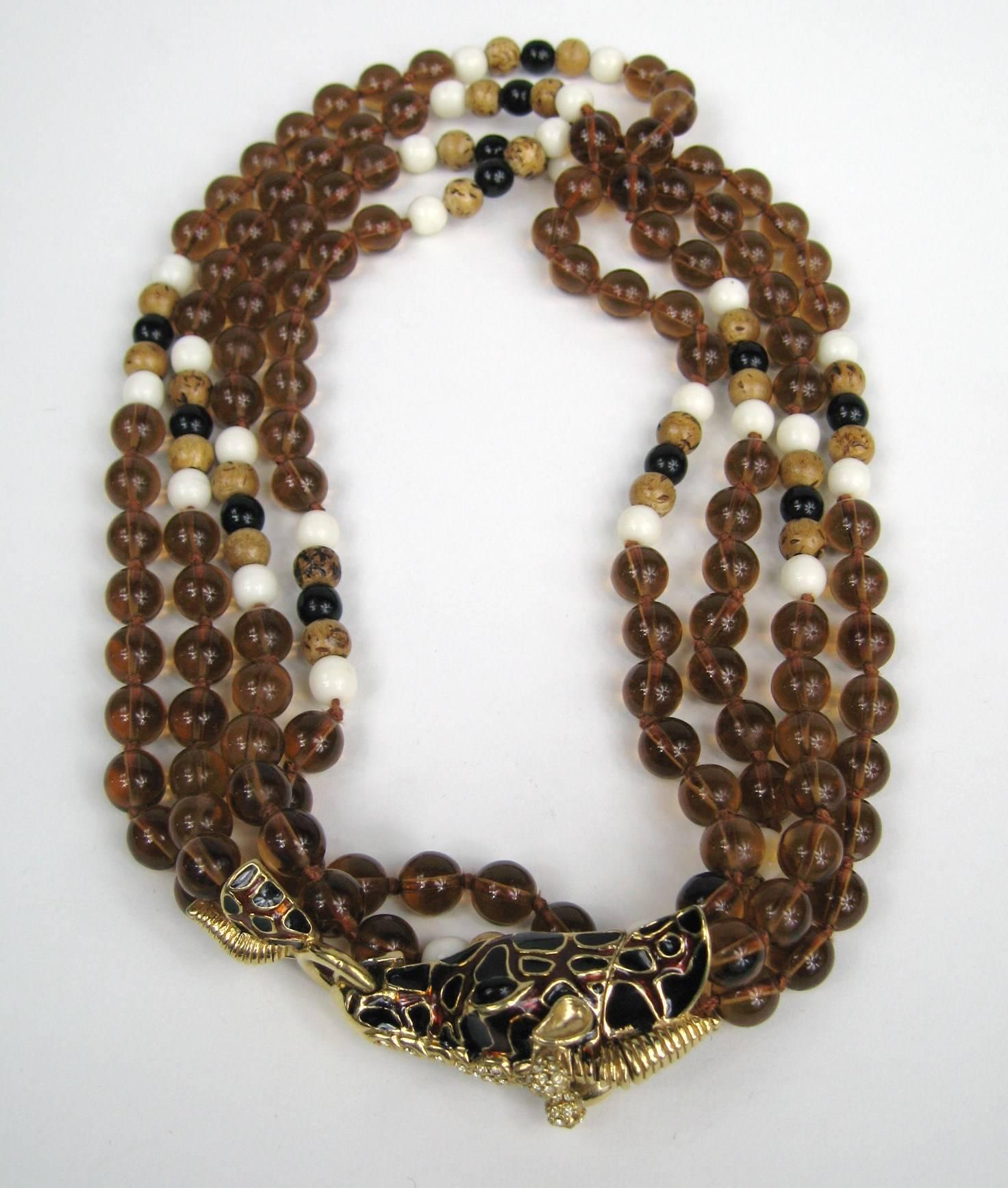 New, never worn  giraffe double strand Ciner Necklace Amber colored, wood and black beading with Black and brown enamel work. Measures 42 inches end to end. It is doubled on the display.  Matching Clip on earrings listed as well. Visit our store