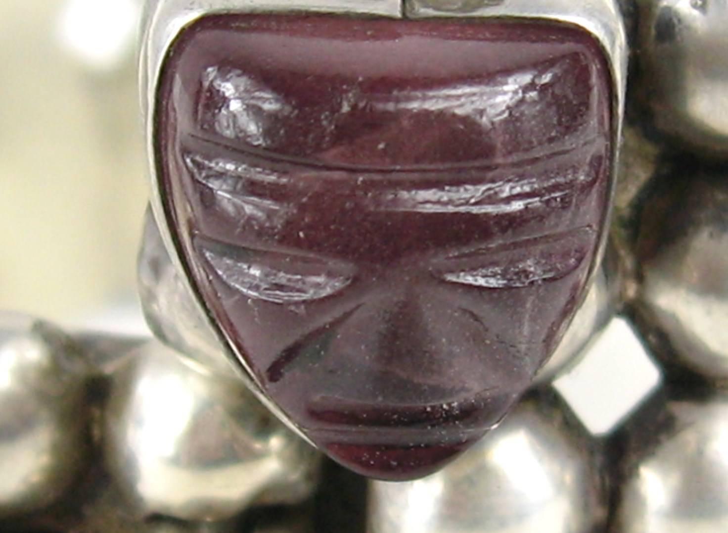 Vintage  Sterling Silver Mexican bracelet. This is amazing in person. Cabochon Round Amethyst Stones set in the bracelet. Main Focus is the carved faces in the front. Measuring 1.05 wide back of bracelet..1.60 wide on the front (head to head) Safety