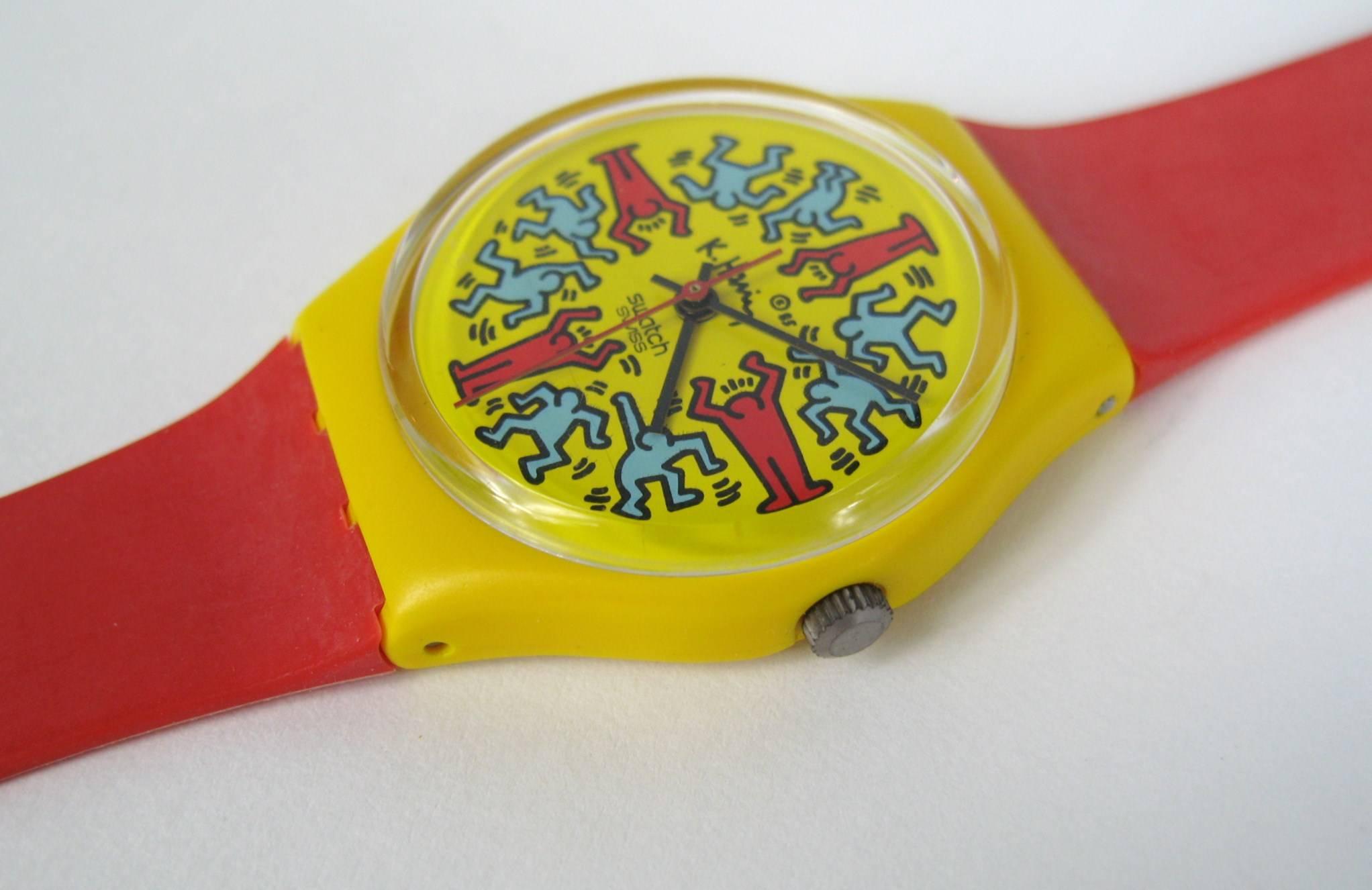 This is a 1985 Keith Haring Swatch Watch, Modele Avec Personnages GZ100. Limited to 9,999 Pieces. In working order. It looks like it was never worn.  We have been selling this collection on 1st dibs since 2013. 