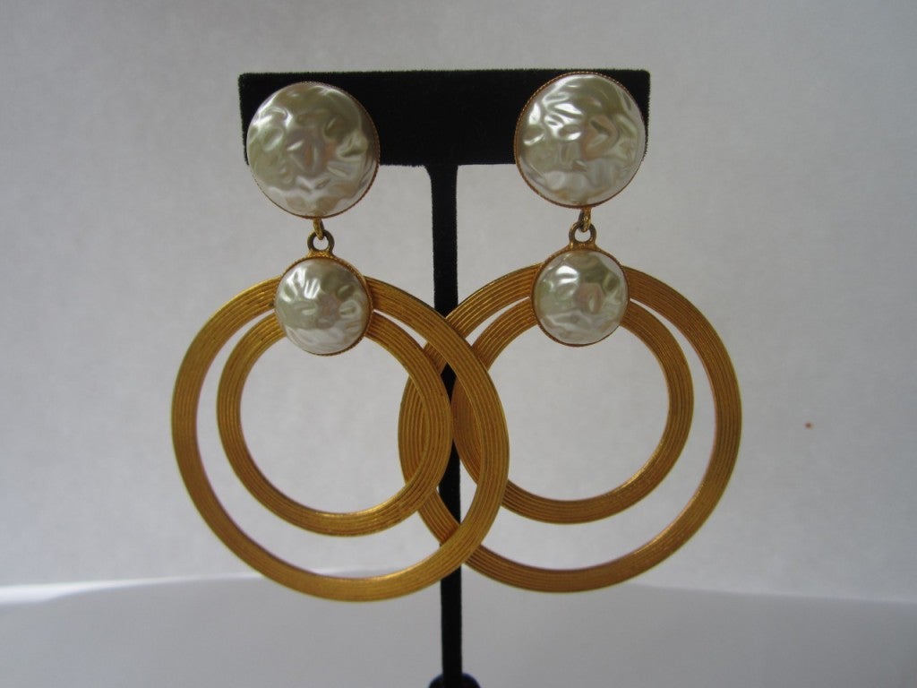 Vintage 1980's Dominique Aurientis Huge Hoops. These are Outstanding! Try and find Aurientis Jewelry, hard to come by and even harder in this condition. Gold tone ribbed Double circle hoops with Two Molded pearl like Bezels. measures about:  90.94