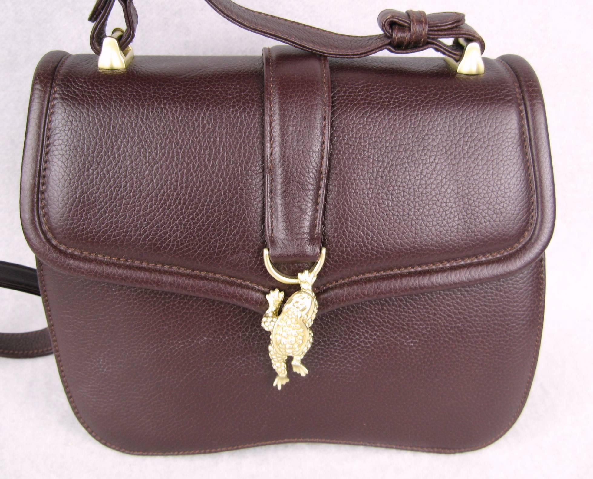 Brown  leather Kieseltein-Cord handbag. This one has a brushed gold tone metal alligator head on the front. Dated 1995.  Comes with it dust bag. Never Used. Measures 8.5 in. x 7 in. x 3 in. deep. 18 in.  Strap which is adjustable. Purchased at