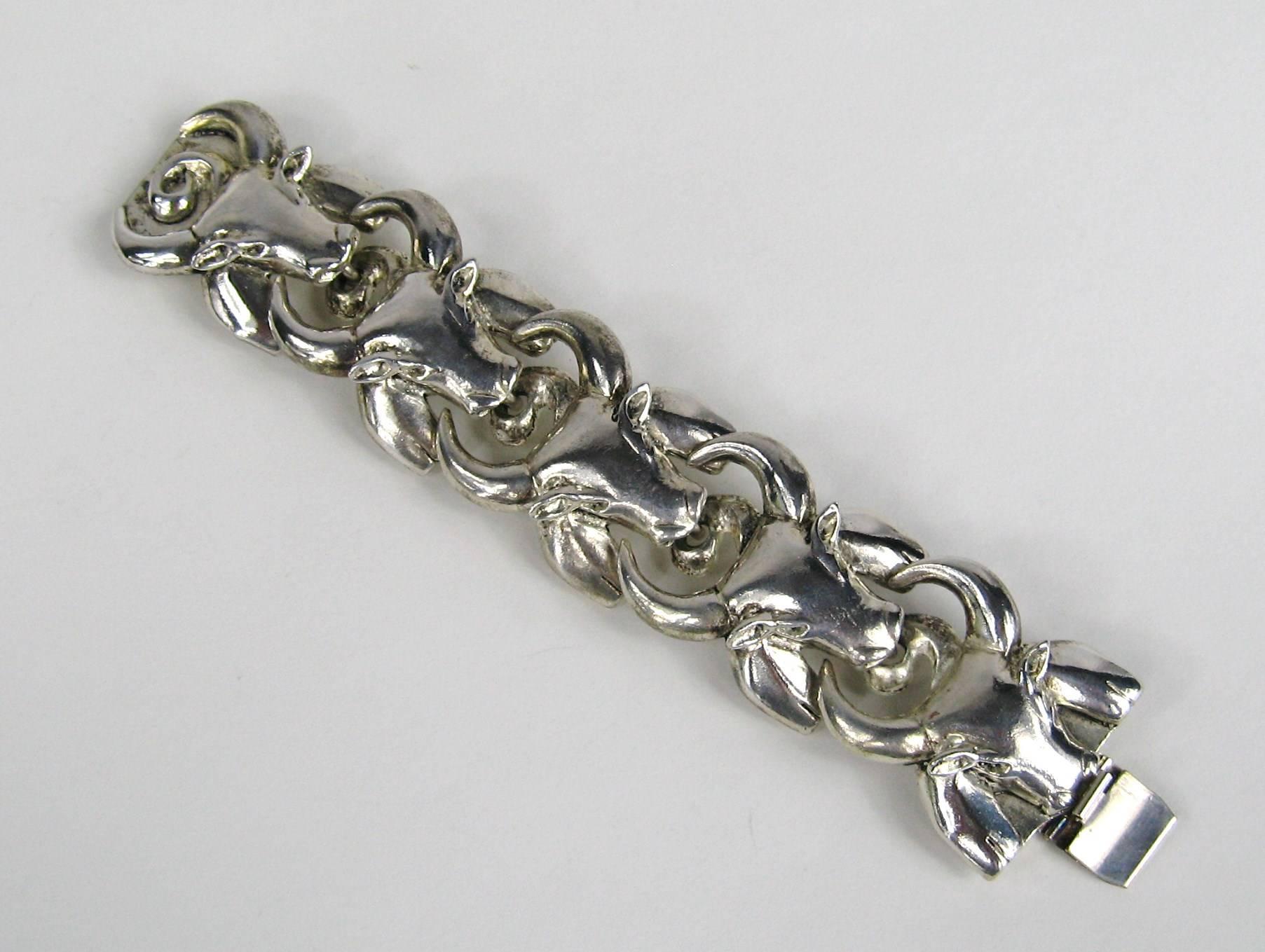 Sterling silver links made up as a Bulls face. Has 6 links. With a slide in clasp. Bracelet is New Old stock from the early 1990s, meaning Never Worn. will fit a 5.5 - 6.25 in.  wrist. It is 1.25