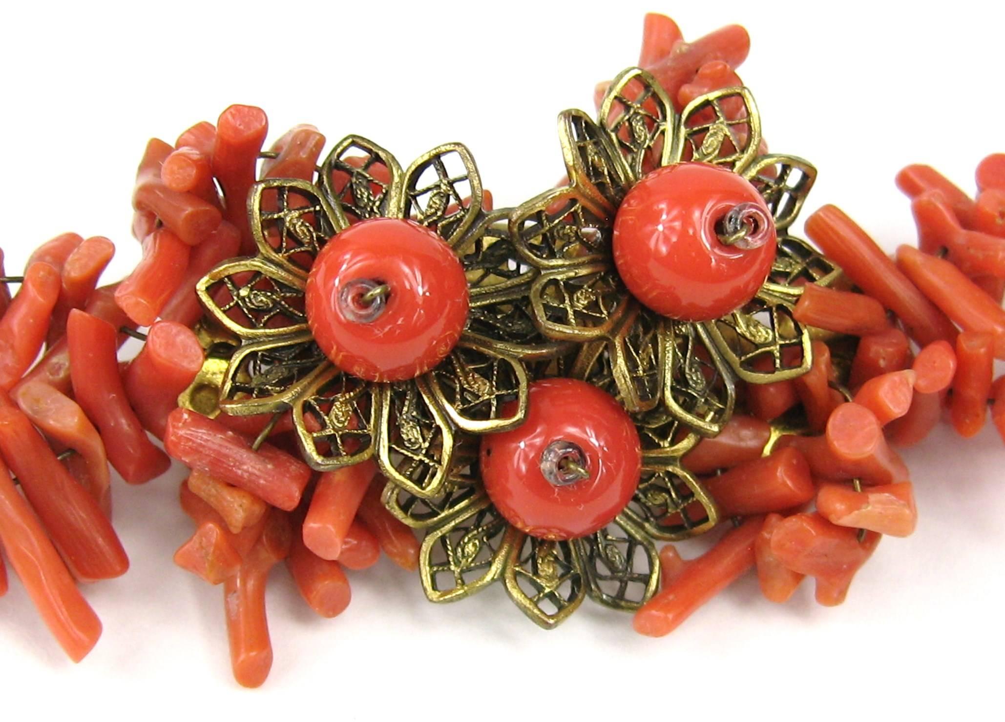 Classic Haskell Stunning! designed by Frank Hess. This brooch features dozens of branch coral beads meticulously hand wired onto a brass frame, and topped with three filigree flowers. This brooch is confirmed to be an early Haskell designed by Frank