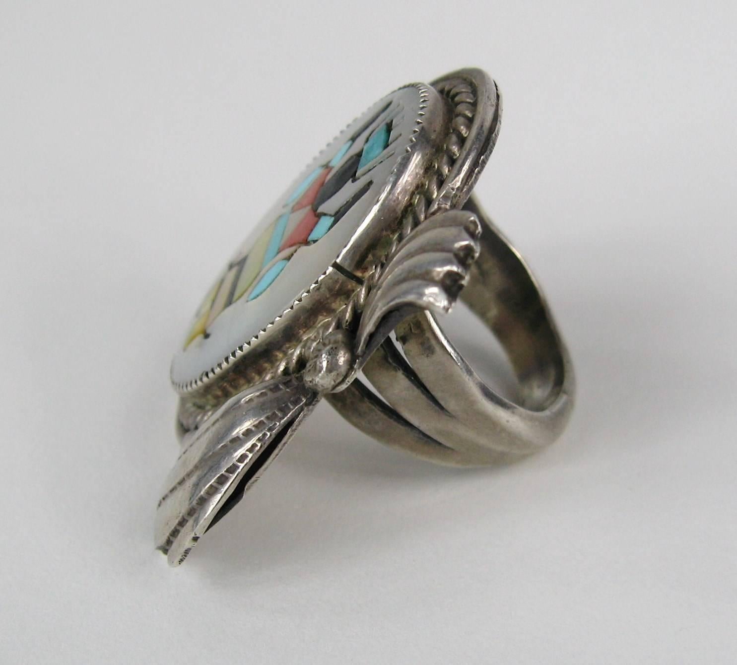 Stunning Craftsmanship on this Gilert Adeky Ring. This has Exquiste inlay. Ring Measures 1.40 in.  top to bottom x 1.30 in. wide. Ring is a size 7. This is out of a massive collection of Hopi, Zuni, Navajo, Southwestern, sterling silver, costume