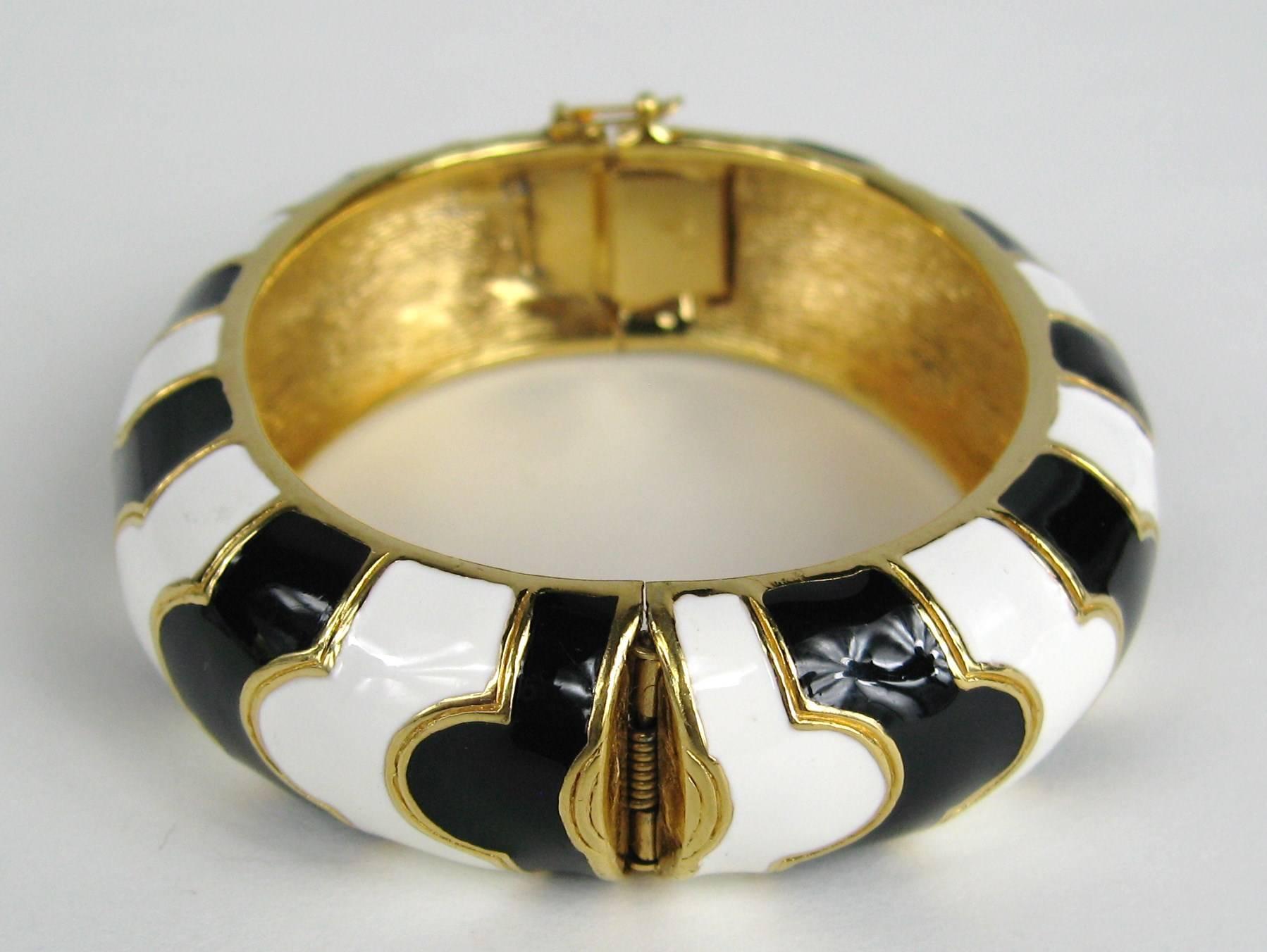 Stunning Ciner bracelet Black and white enamel with gold accents. Hallmarked Ciner. Hinged bangle, Price tag still attached from Neiman Marcus Measuring .75 inches wide. Will fit a size 6-7 in. wrist nicely Matching earrings and necklace available