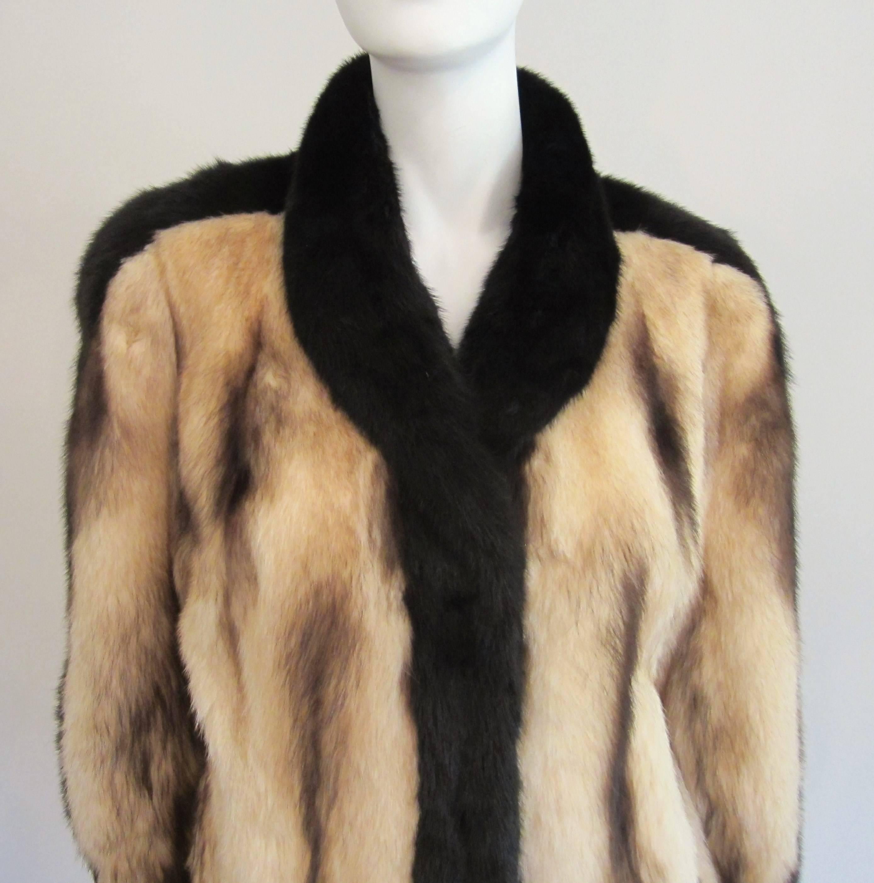 Stunning Fitch jacket with Mink accents. The jacket measures up to a 40 inch bust--- up to 44 inch waist --- length 31 inches down the back. This can certainly be worn by both a man or woman. Banded cuff, french hem, 3 hook closure and 2 slit