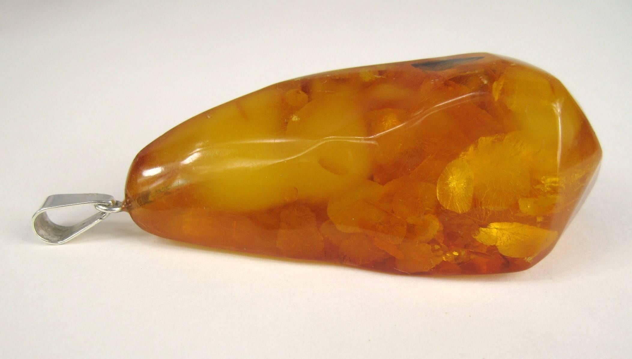 Huge Amber pendant with a sterling silver bale Measuring 3 in top to bottom x 1.50 in wide x 1 in thick. It has a Large bale to accommodate any size chain. This is out of a massive collection of Contemporary Fashion as well as  Hopi, Zuni, Navajo,