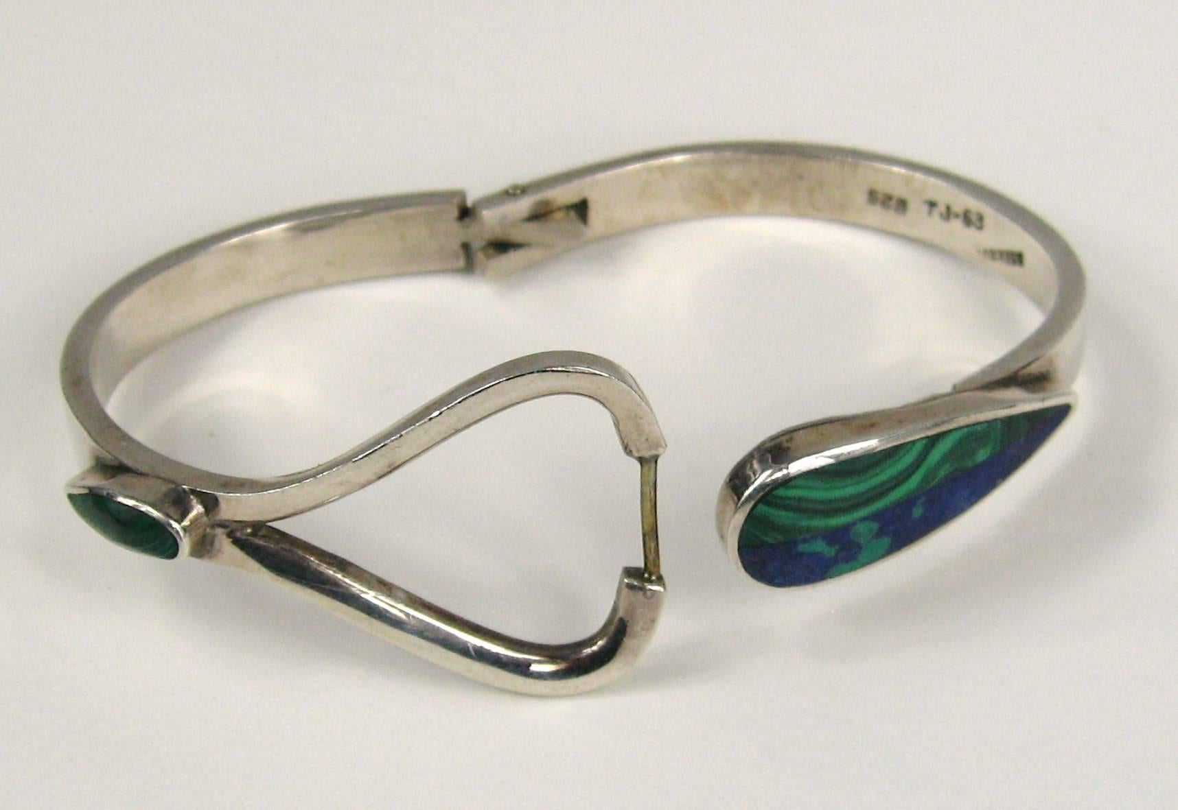 Fabulous Malachite and Lapis sterling silver bracelet. Bracelet has a hidden latch under the bezel set Lapis - Malachite stone, hinged back. Hallmarked inside the bracelet  1.12 inches at widest This is oval in shape an will fit a 6 inch up to a 7.5
