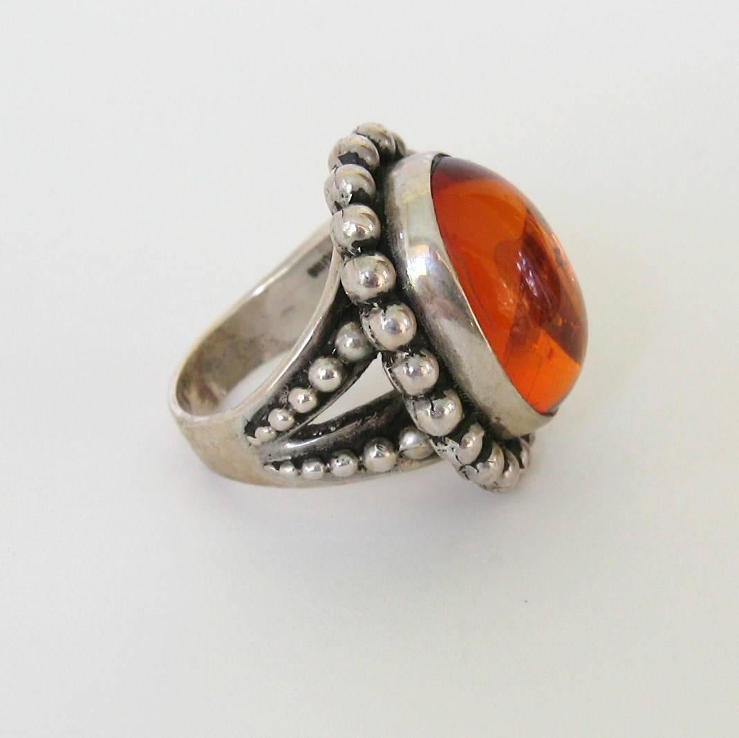 Fabulous Large Amber Sterling Ring with a Bezel Set Amber- Beaded Motif Surrounding Stone. With a  Substantial amount of sterling makes up this Ring    Hallmarked Stephen Dweck & Sterling Silver. Measuring 1.07 x .90  Size is 6.5. Stephen Dweck has