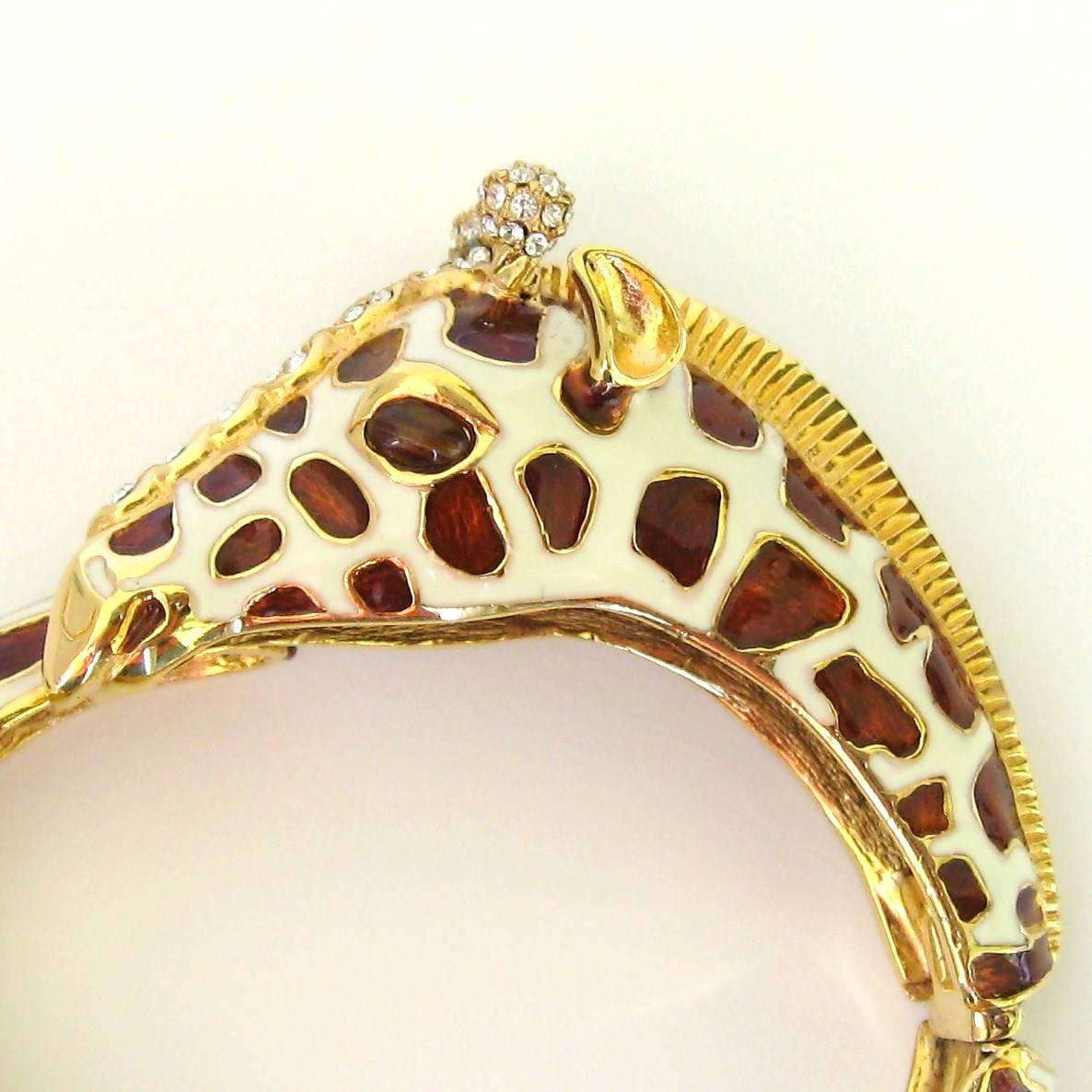 Ciner Giraffe Rhinestone Enamel Bracelet. Has a gold toned base with cream enamel, Swarovski Crystal  adorn this bracelet. Inside Measures 7 inches. This piece is New With Tags from Neiman Marcus purchased back in the 1980s. This is out of our