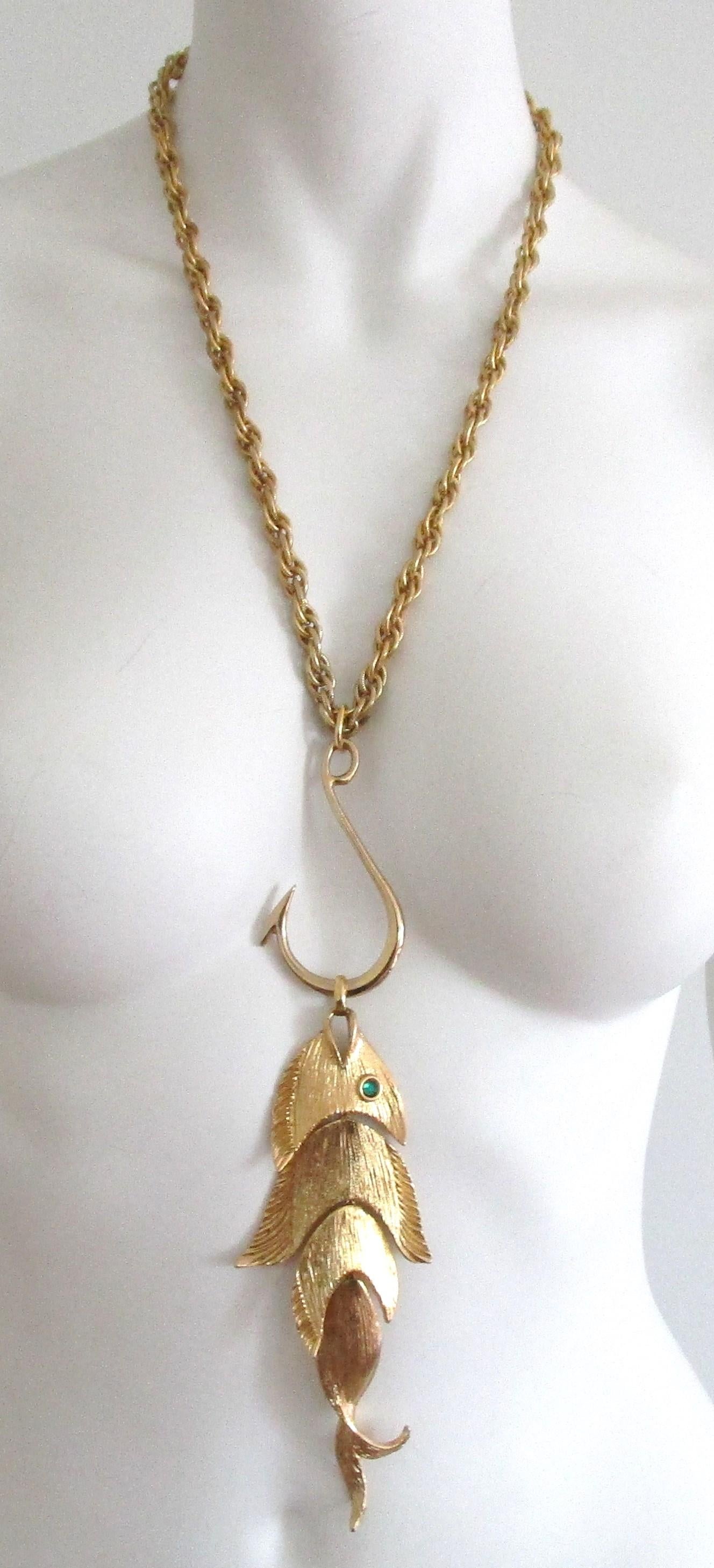 Fantastic Vintage Napier Articulated LARGE Fish Pendant Necklace. Hallmarked on the backside Napier. Brushed Gold Tone metal finish. Green faceted eye in the fish. Large chain measuring approximately 24.5 inches end to end. The Hook and Fish measure