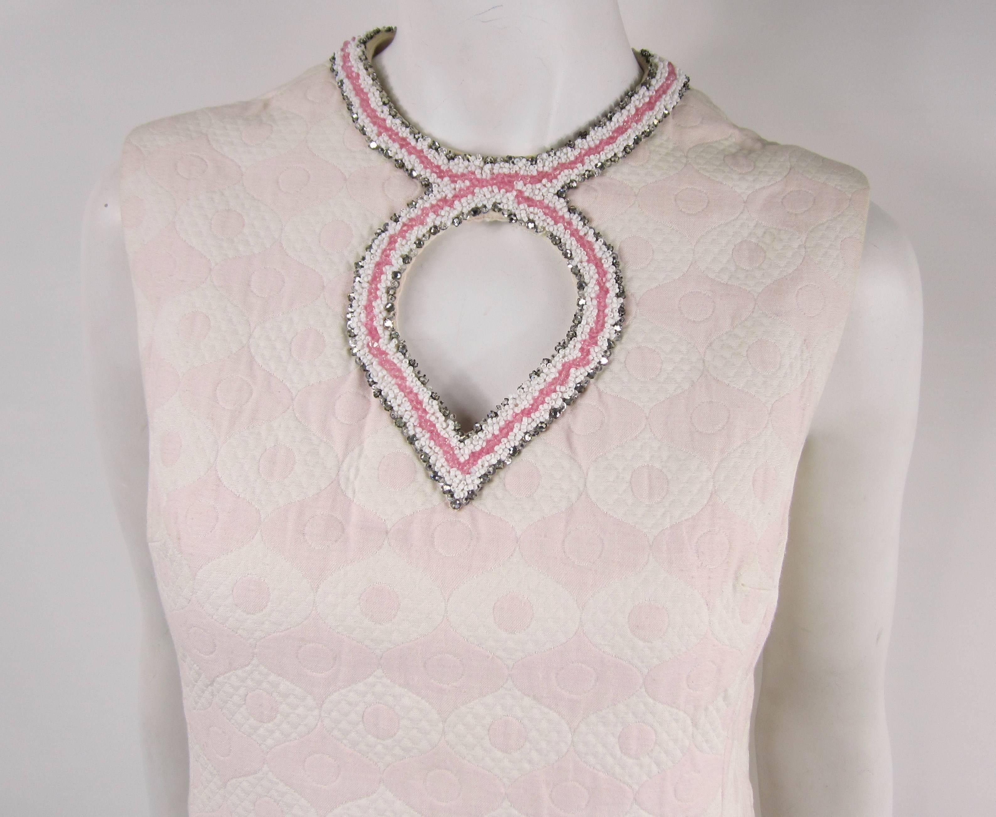 1960s Pink and white Matelesse Tunic with pants with fantastic Beading on Pants and tunic. Sleeveless tunic with keyhole neck. Pockets on the tunic and Zips up the back. Pink and white bead trim on tunic and on the pant. Measuring. Bust up to 34