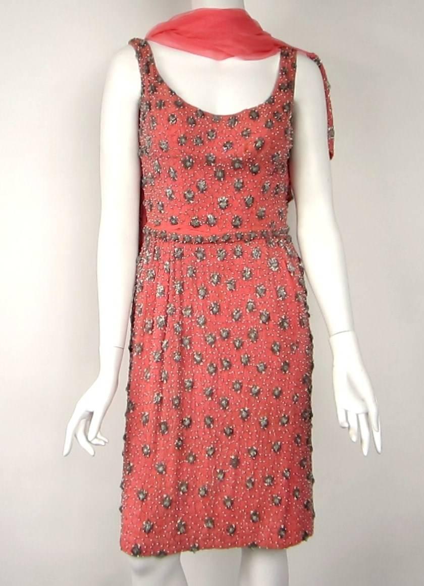 Coral Background with hand sewn beading with a Matching Shawl Scarf. Detachable matching belt. Slit Pockets in the dress with a wonderful Low back. Bust: 34  Waist: up to 26 Length: (shoulder to Hem) 27.5  Hips: 35 Length: (waist to hem) 27.5 Shawl