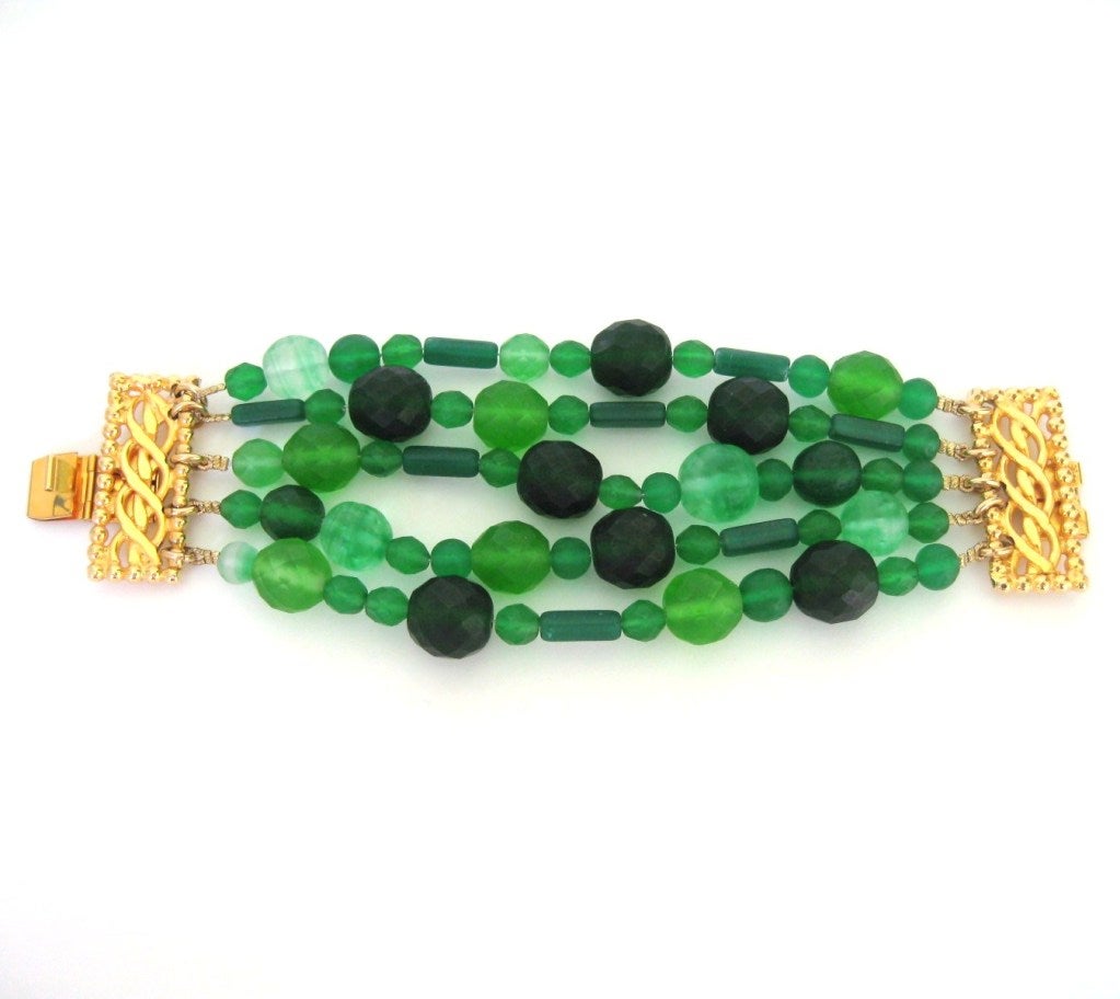 Dominique Aurientis Glass Bracelet with different shades of green glass beads. Simply stunning! 5 strands on this one. Work of art on your wrist. Will fit a 6.5 to 7 inch wrist. Nice Bold look. This was made smaller. I do have the extra beads if you