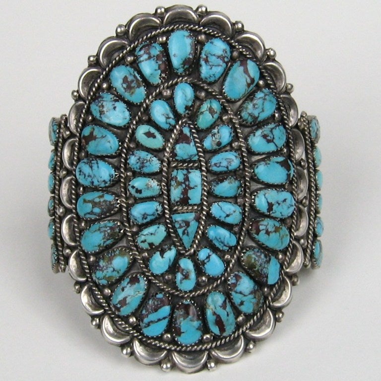 Massive Native American Zuni Needlepoint Silver and Turquoise Oversize Cuff/ Bracelet Turquoise has a slight red matrix running in it. The turquoise is set in a saw tooth bezels. This is a super large and nice bracelet!  One of the better ones that