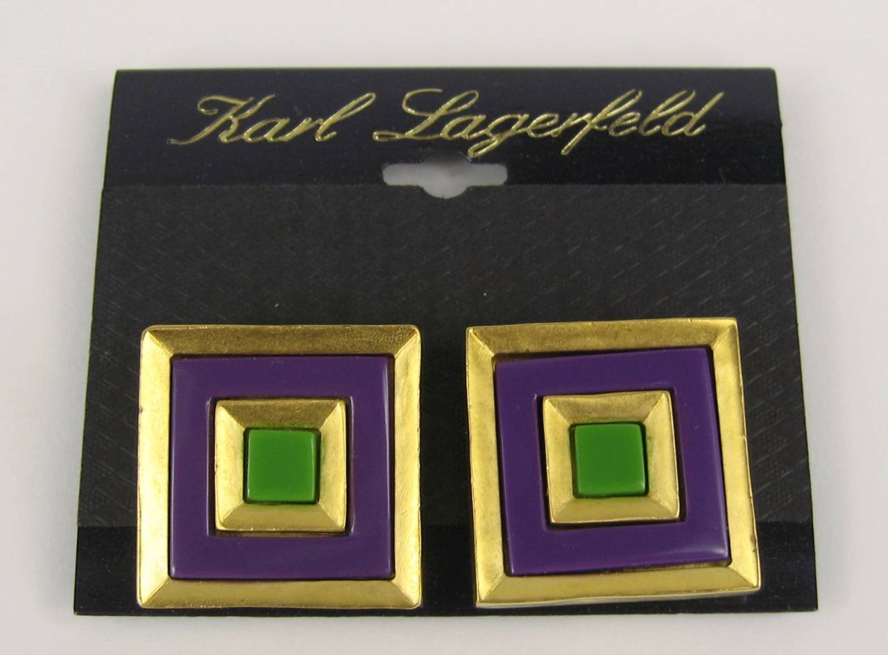 Purchased and stored away till now, vintage 1980s Lagerfeld Square Purple and green enameled earrings. Still on earring card. Measuring 1.11 in square. Necklace, Earrings, charm Bracelet and Bangle are all listed on our storefront. This is out of a