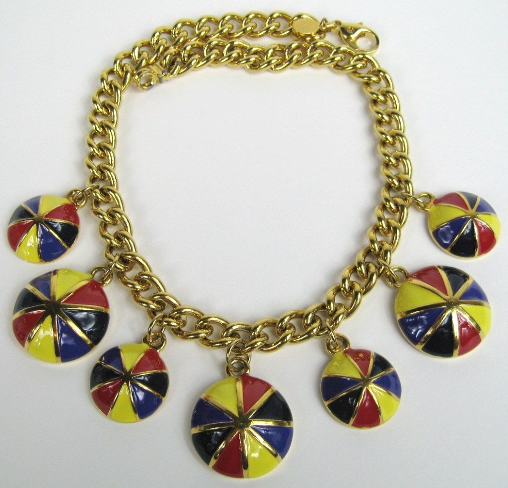 New with tags, deadstock. Purchased and stored away. 1980s Escada Enameled Jockey Caps dangling off of a gold-tone metal chain. Bright and colorful, add pop to your wardrobe. Yellows, Red, Purple Black Pinwheel of color! Big to small, Big to small